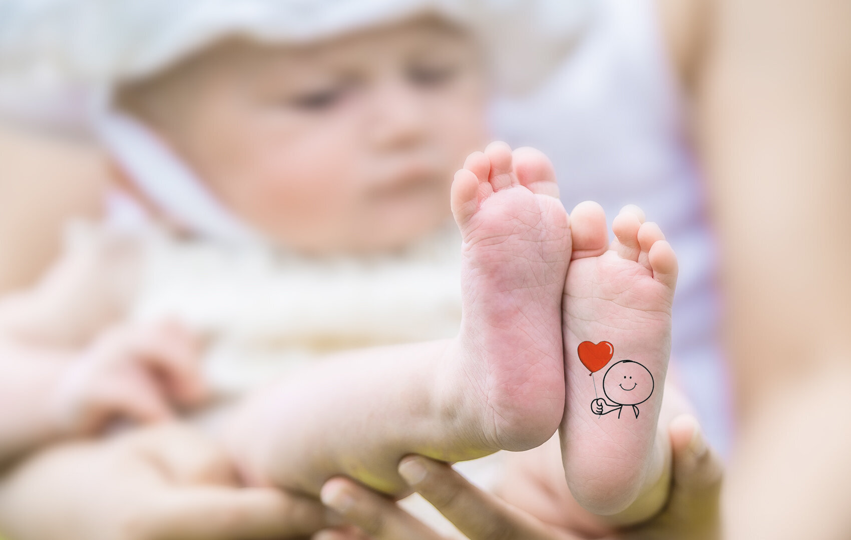 Baby photography on Maui, cute tattoo on foot.