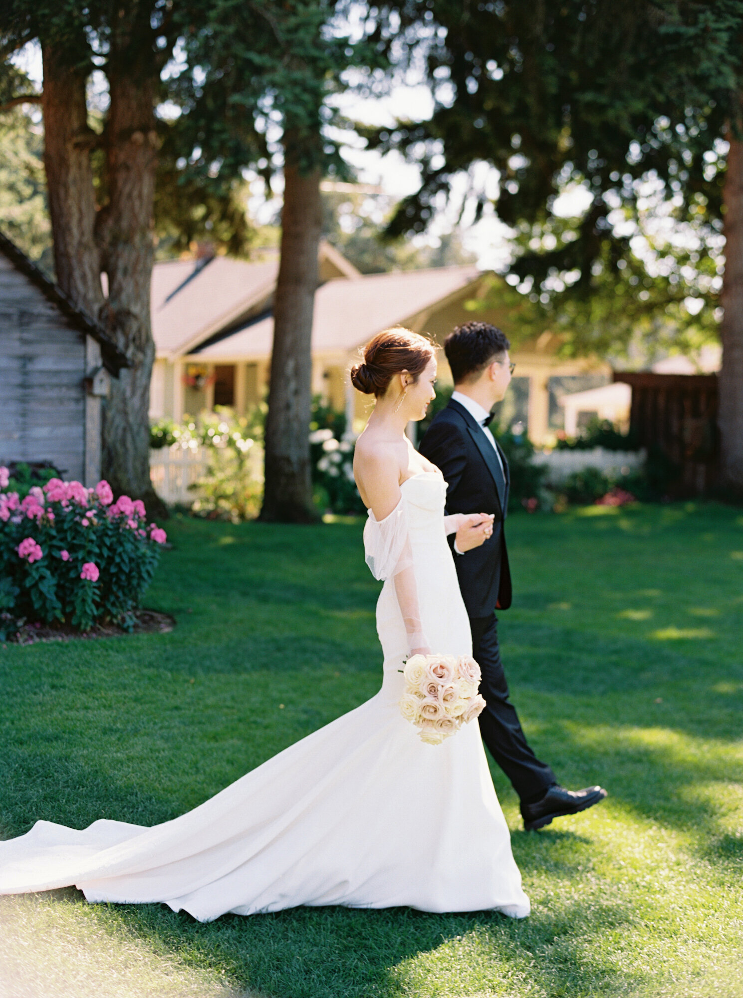 profile of bride and groom walking in garden hand in hand