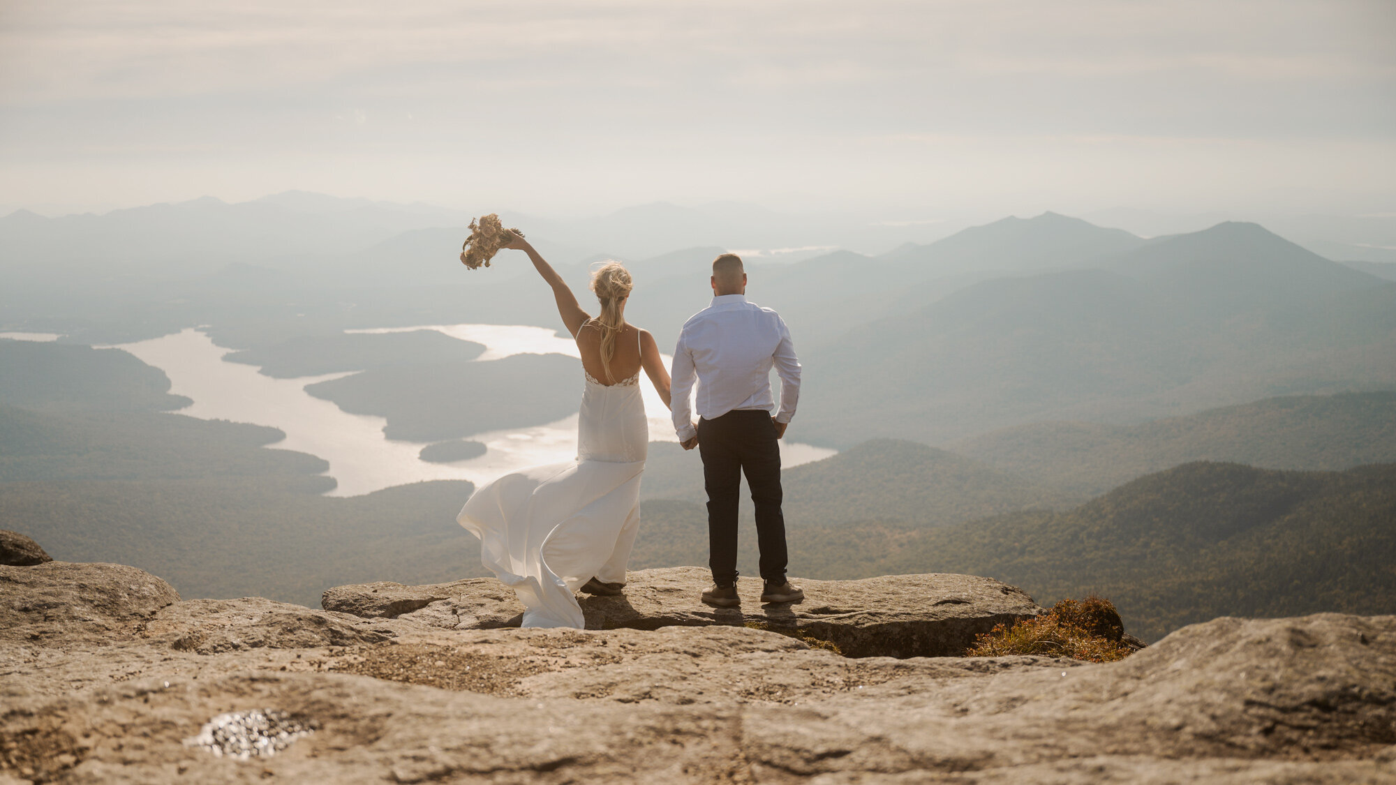 The bride and groom taking in the views of Lake Placid during their Whiteface Mountain elopement.