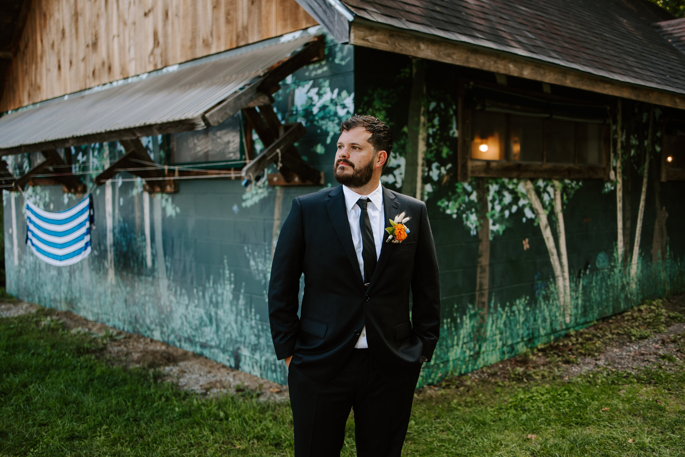 Groom looks away from camera in Vermont
