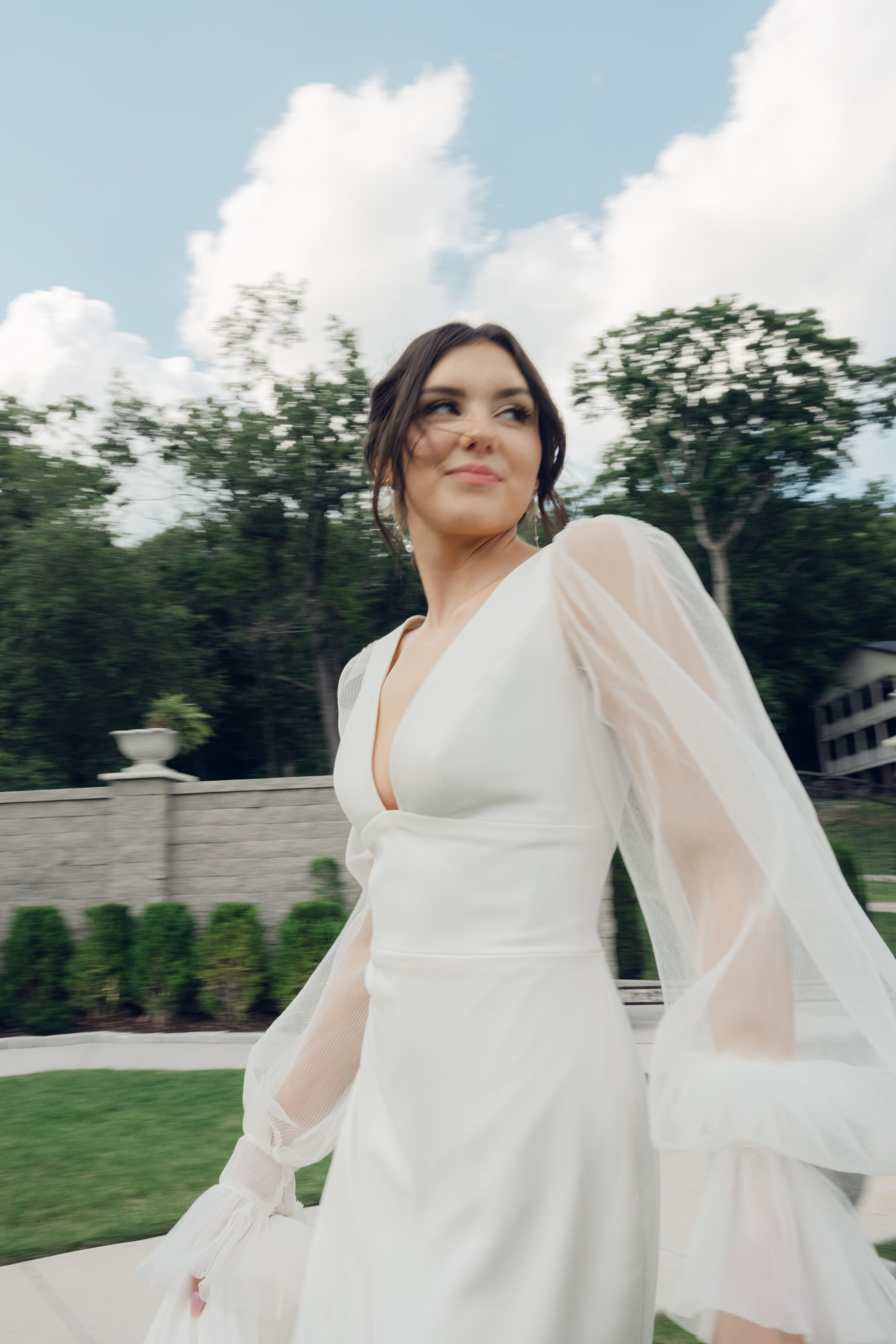 Bride twirls outdoors, radiating happiness in a flowing gown
