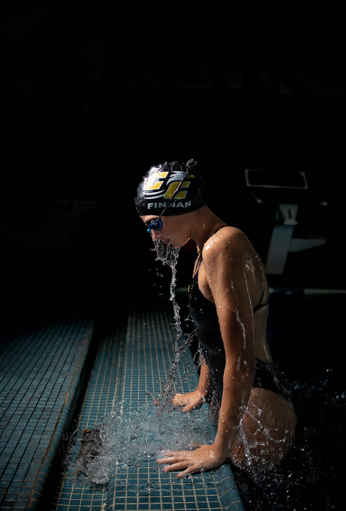 High school senior swimmer from colonel crawford high school jumping up from the water - side view
