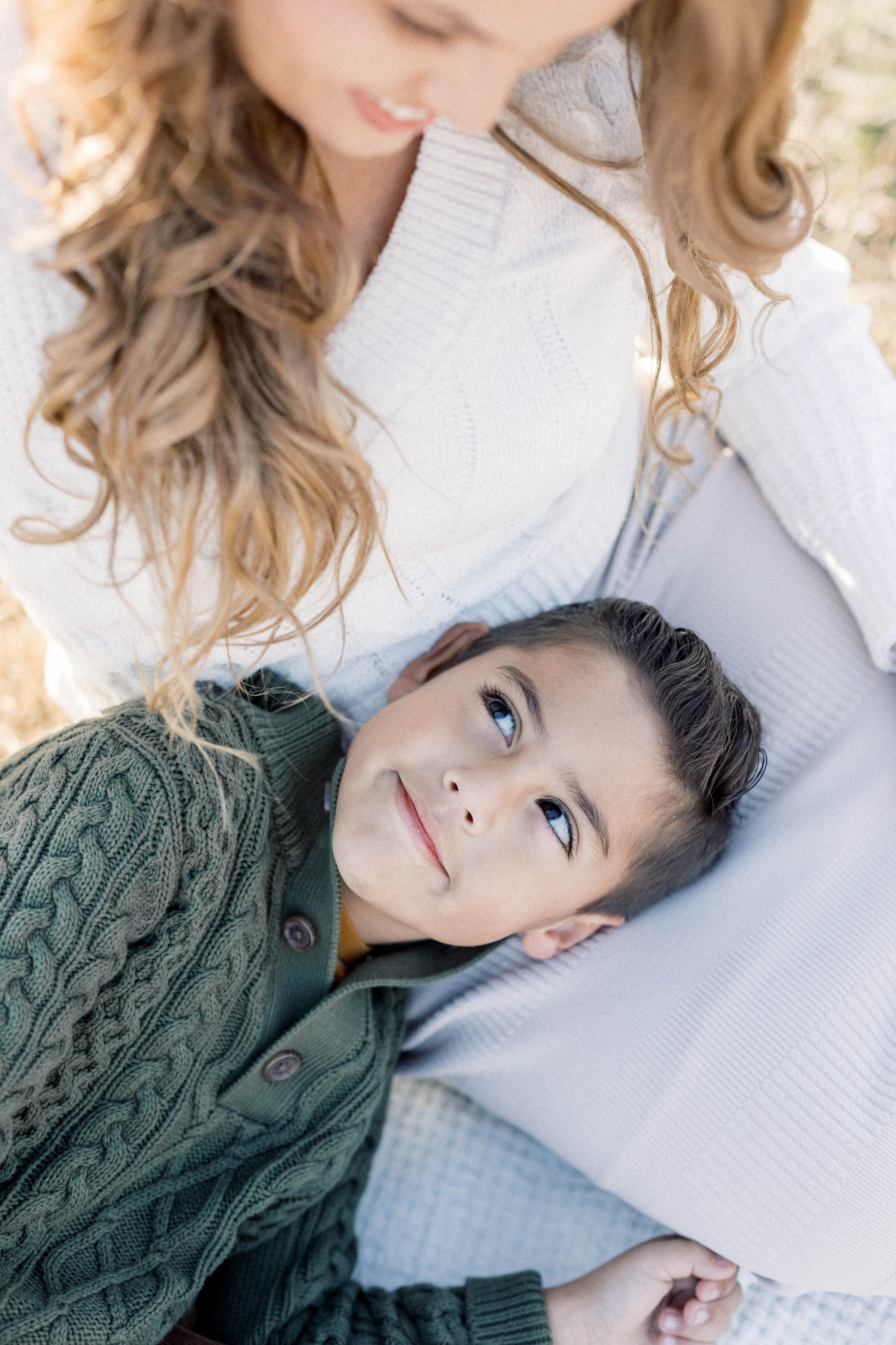little boy laying in womens lap looking up at her smiling  knoxville tennessee newborn photographer
