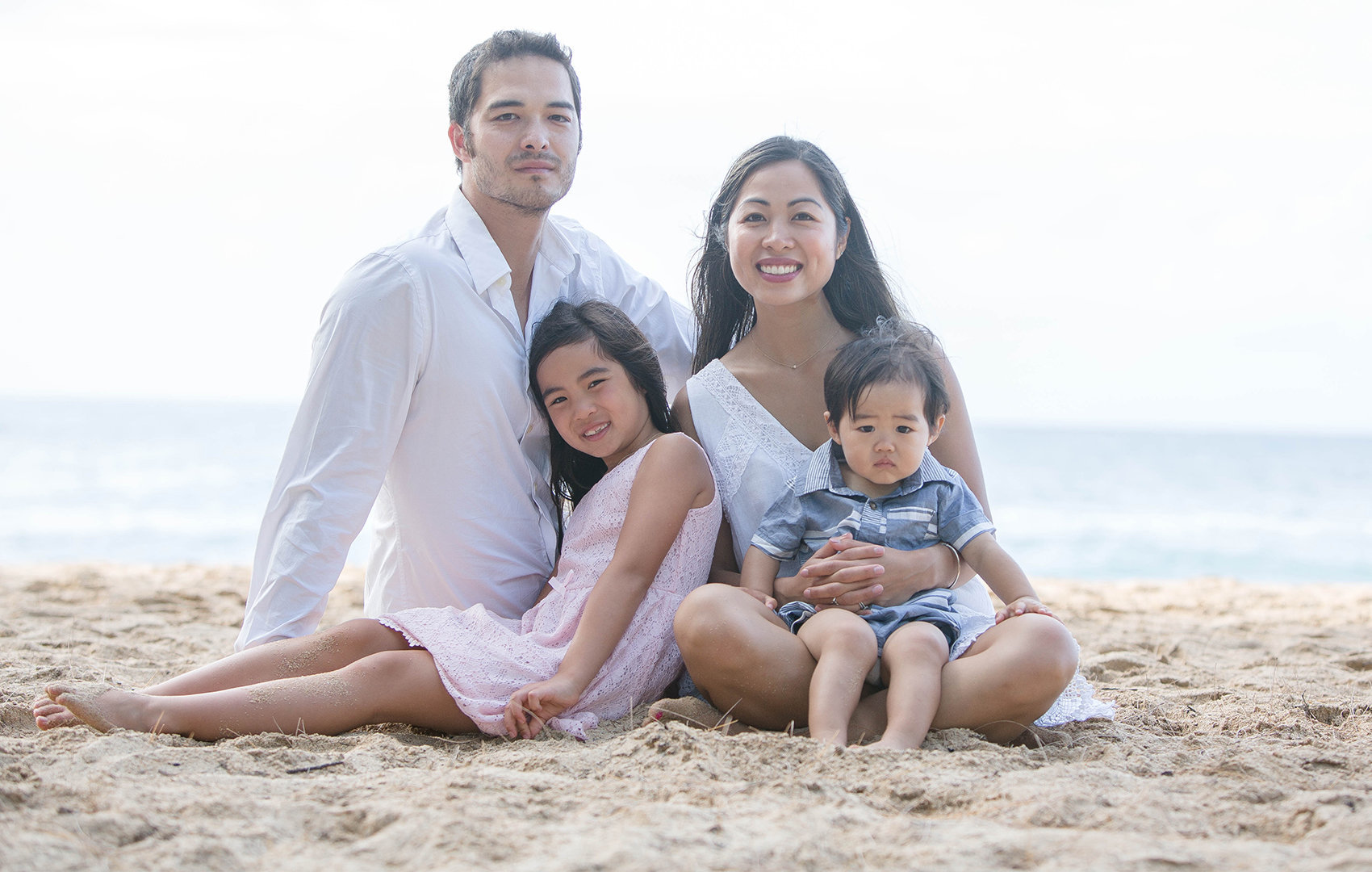 family enjoy their portrait allalon on the beautiful beaches of Oahu.
