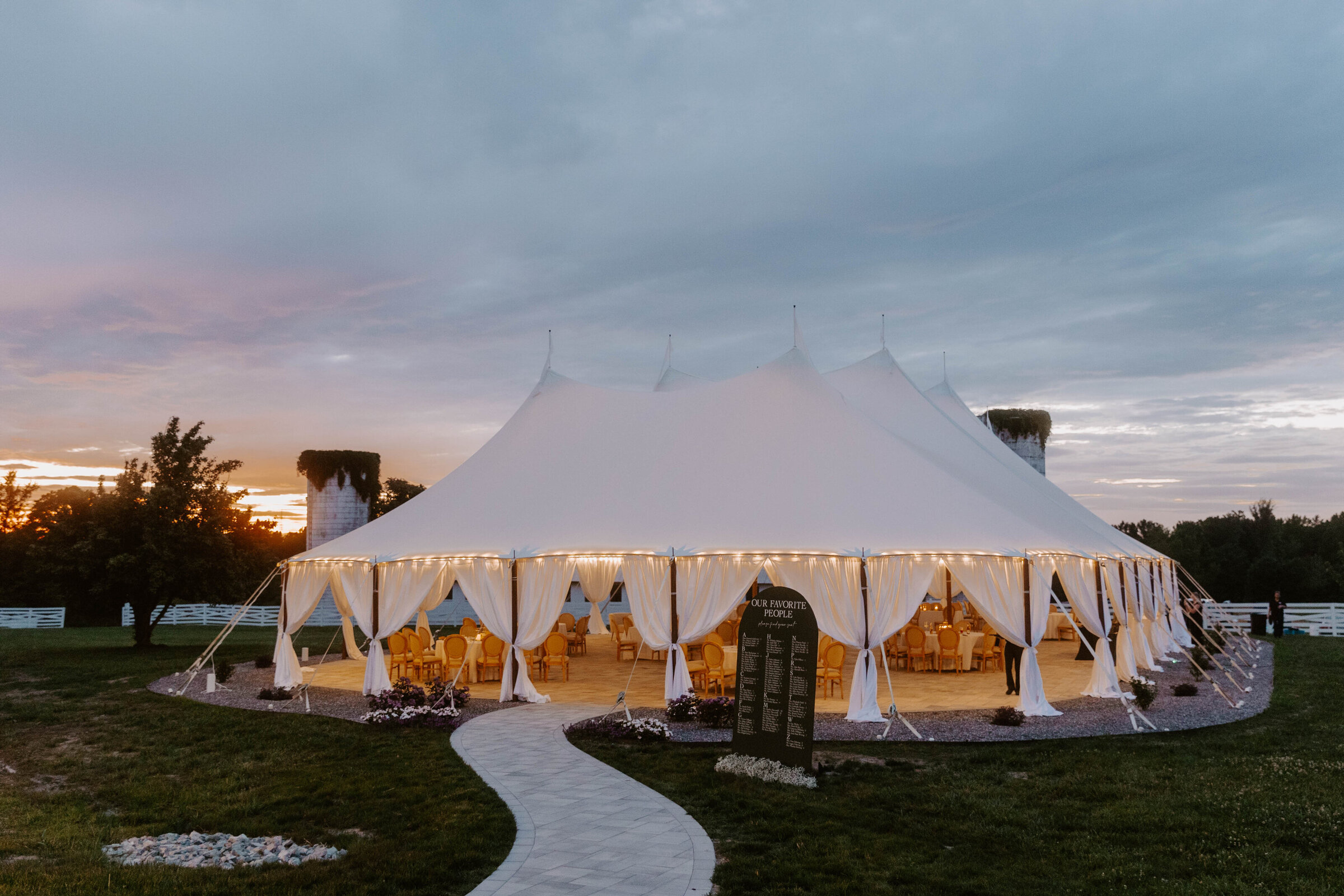 The sailcloth tent lit at dusk at Northfield Estate