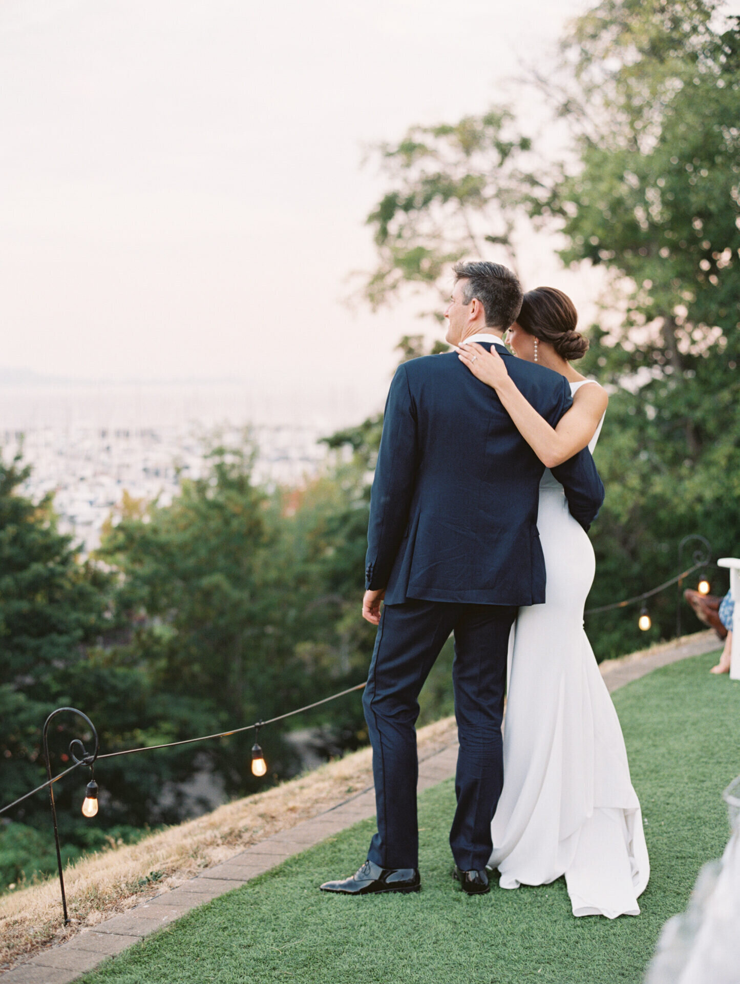 couple overlooks water on their wedding day