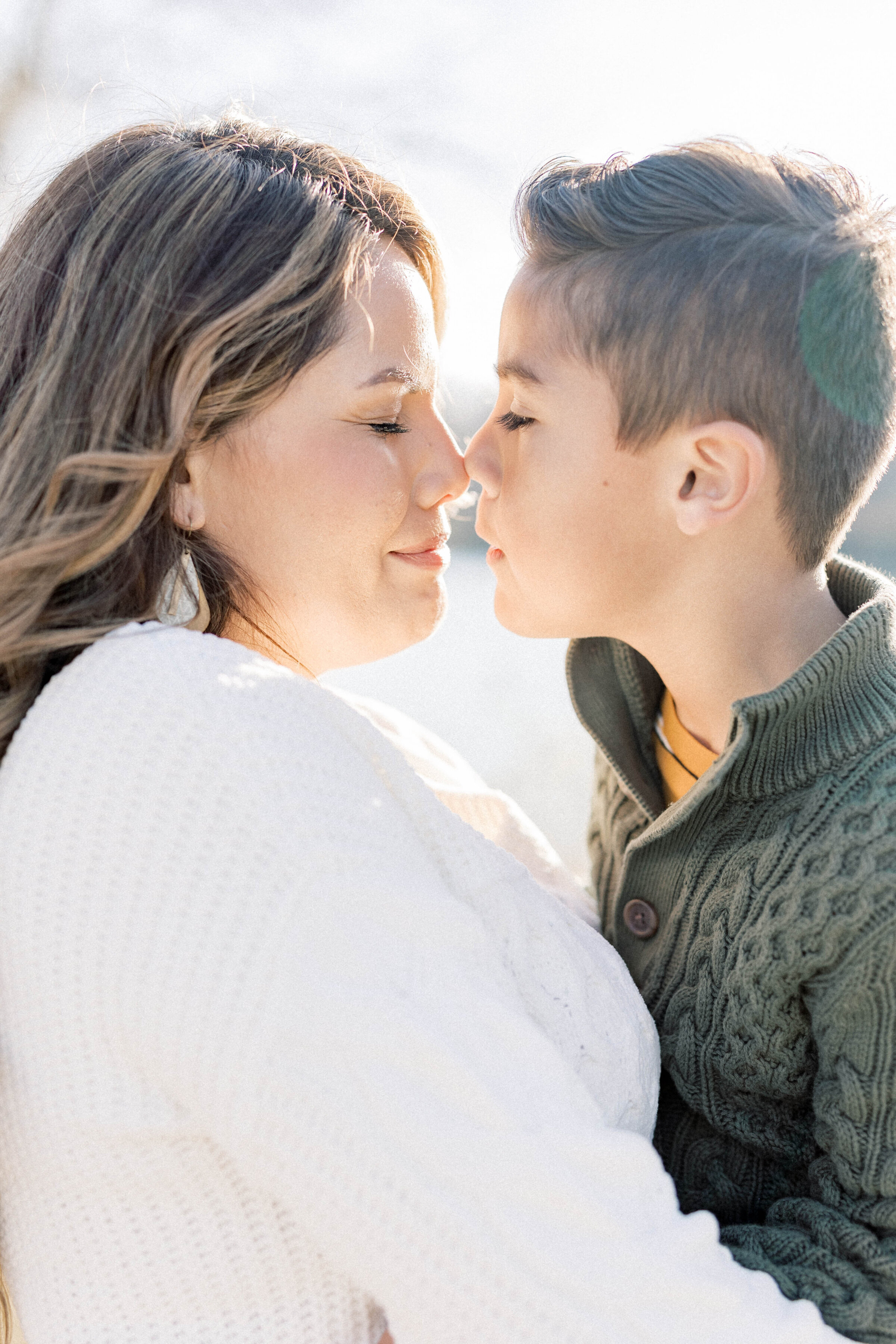 women and little boy nose to nose with sunlight behind them  knoxville tennessee newborn photographer