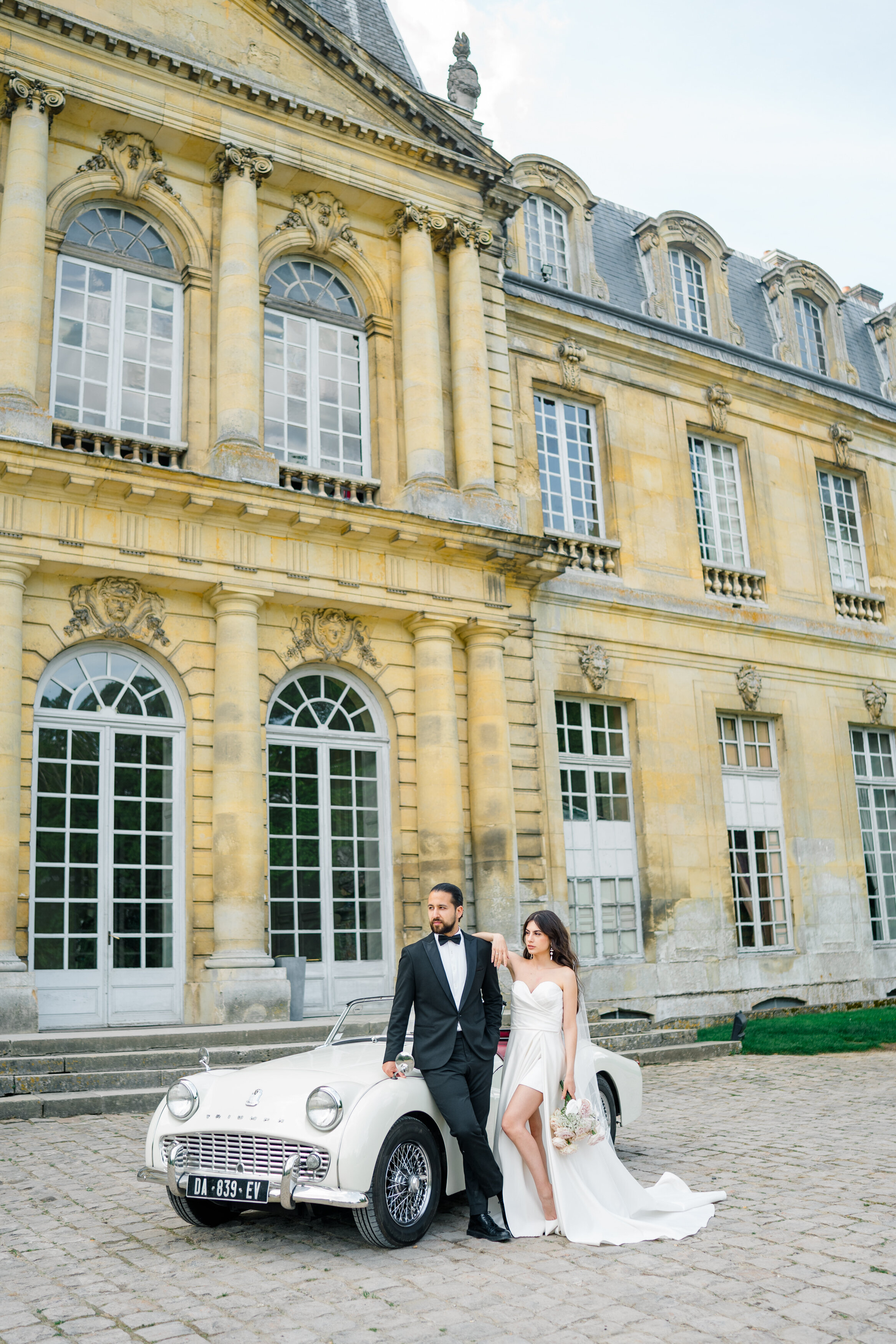 Wedding and Elopement Photographer, couple standing in front of old car and estate