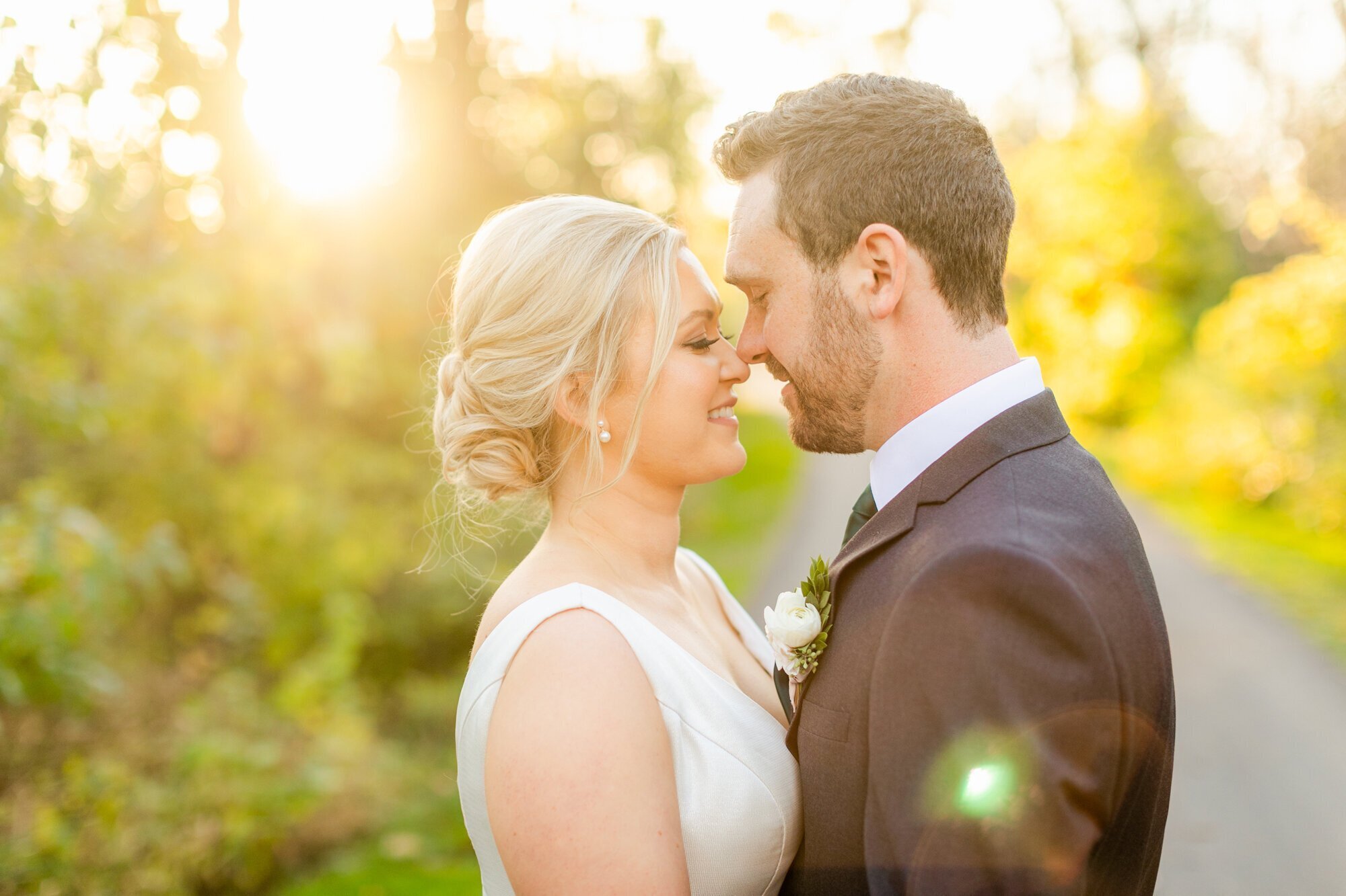 Bride and groom touching noses for portraits, taken by wedding photographers in minneapolis