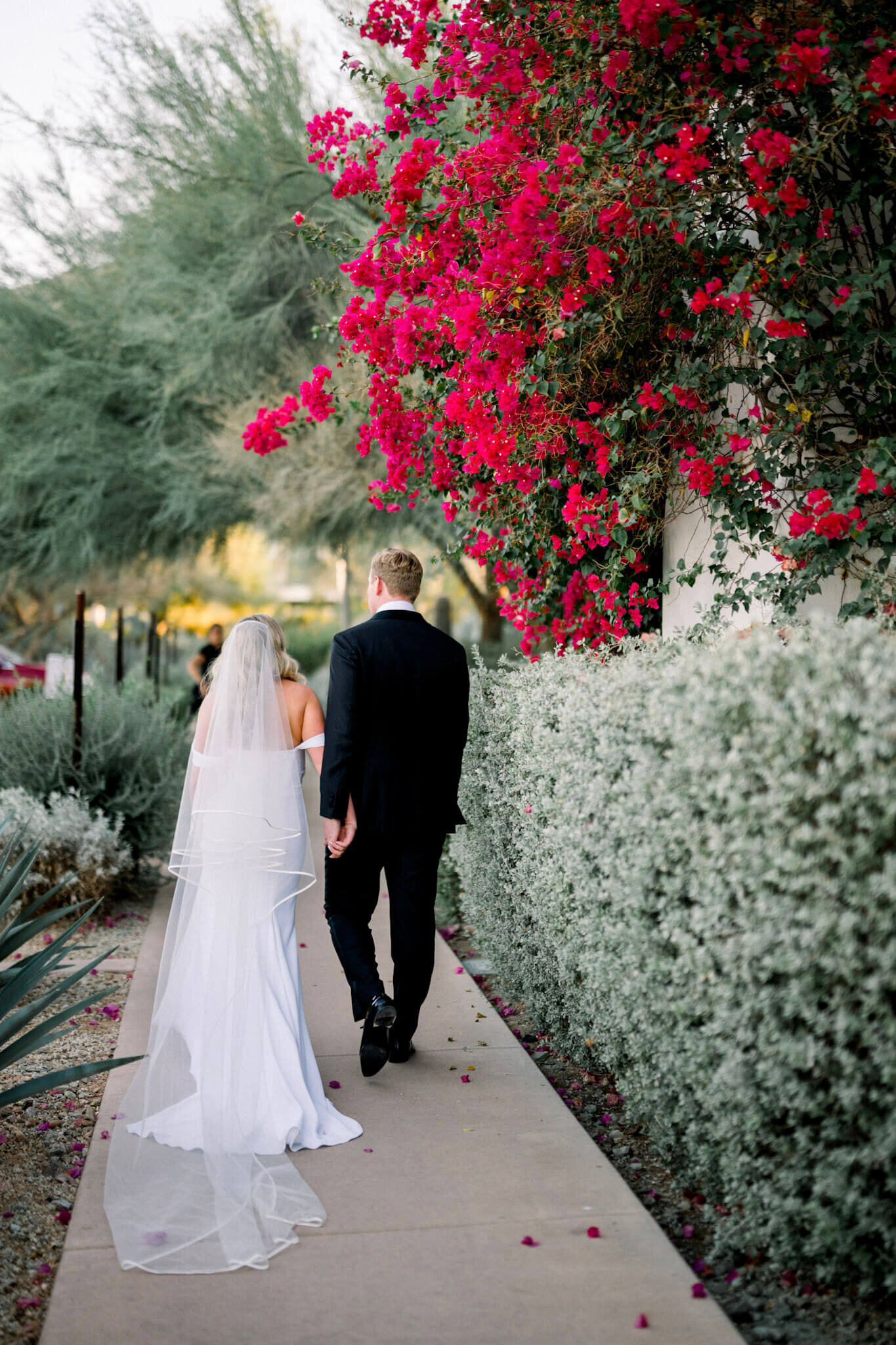 Bride and groom on a walkway after reception. 