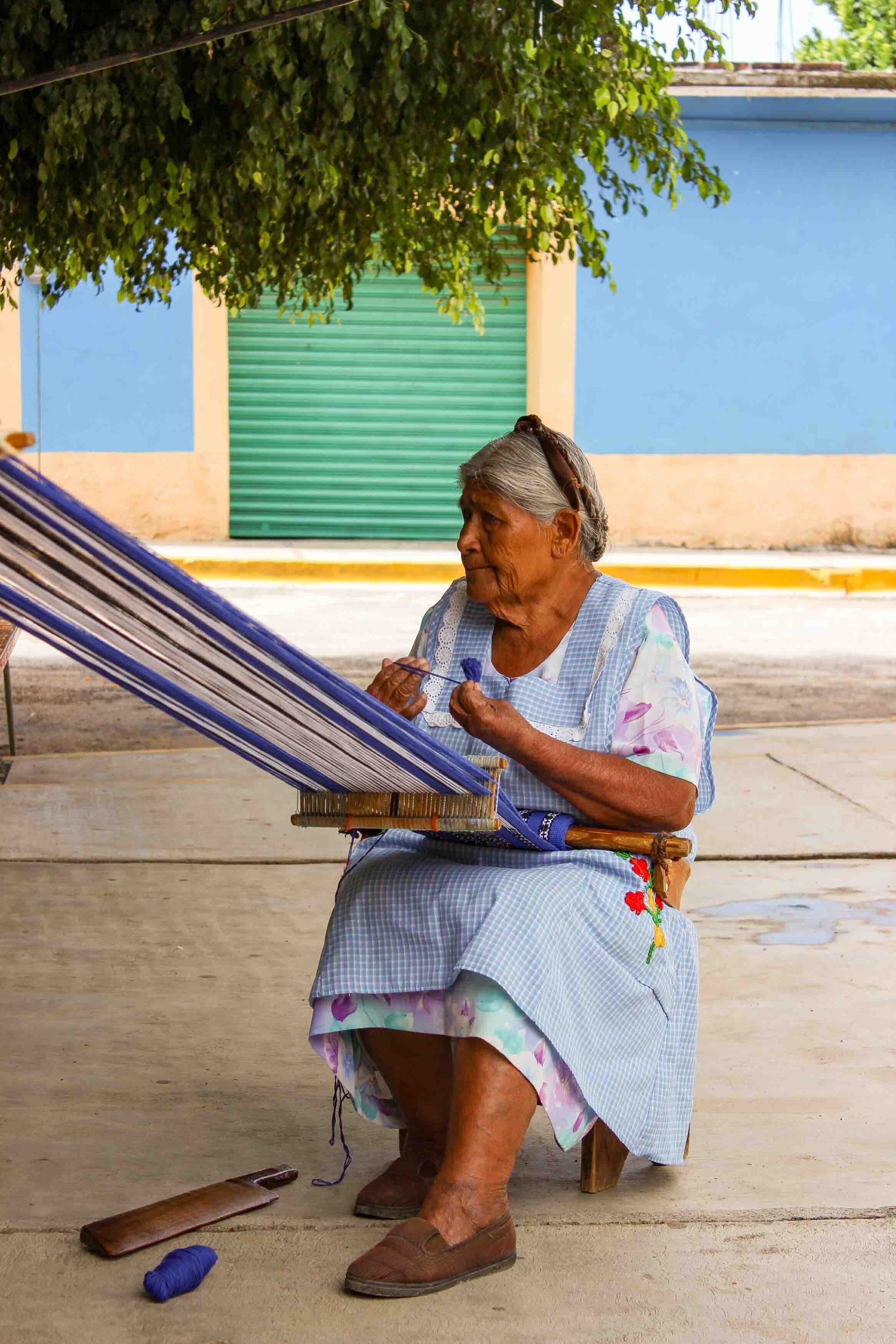 A woman weaving on a backstrap loom near Oaxaca, Mexico, a to destination for local crafts ©Stephanie Dosch | theViatrix Luxury Travel