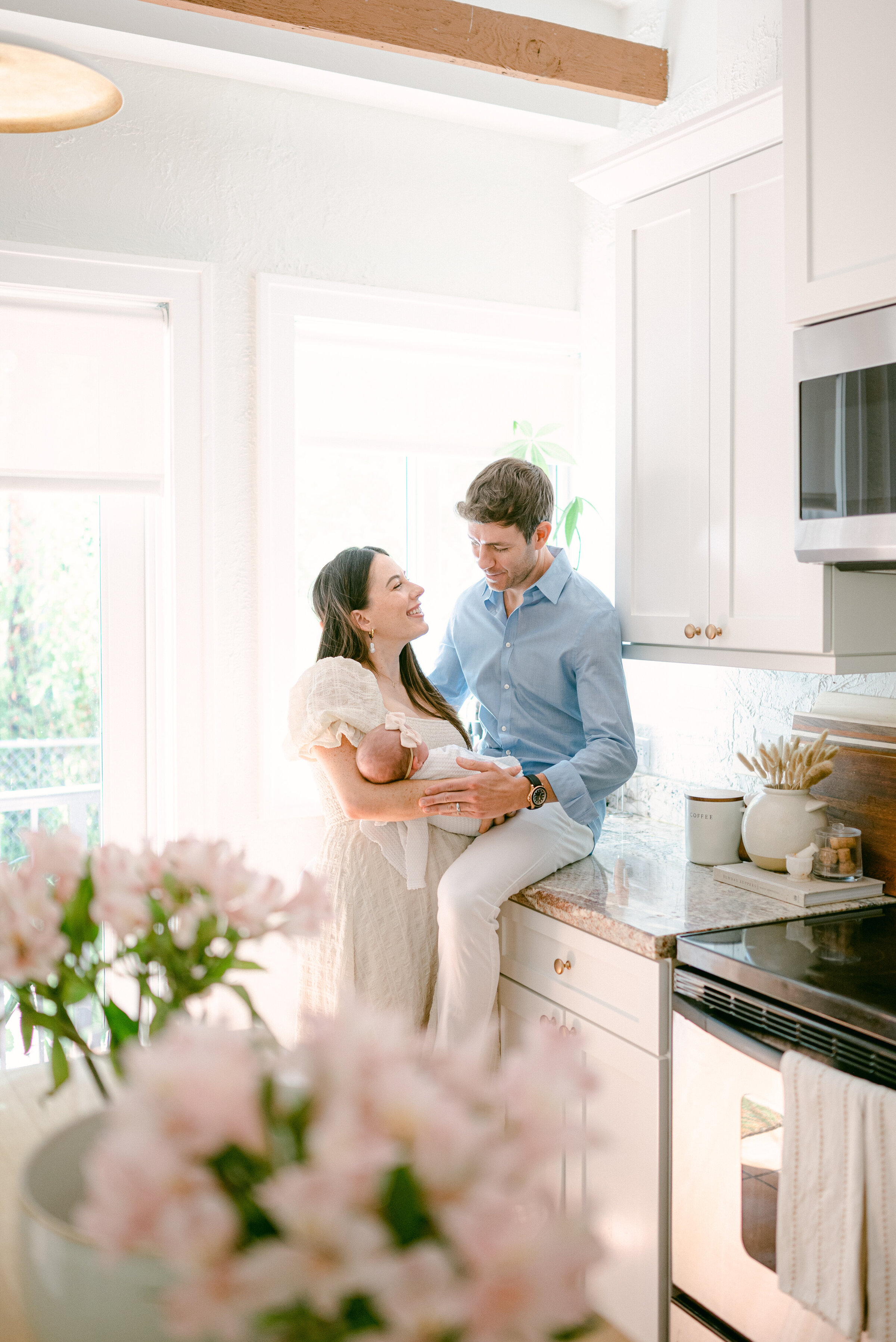 Family cuddling in the kitchen by Miami Newborn Photographer