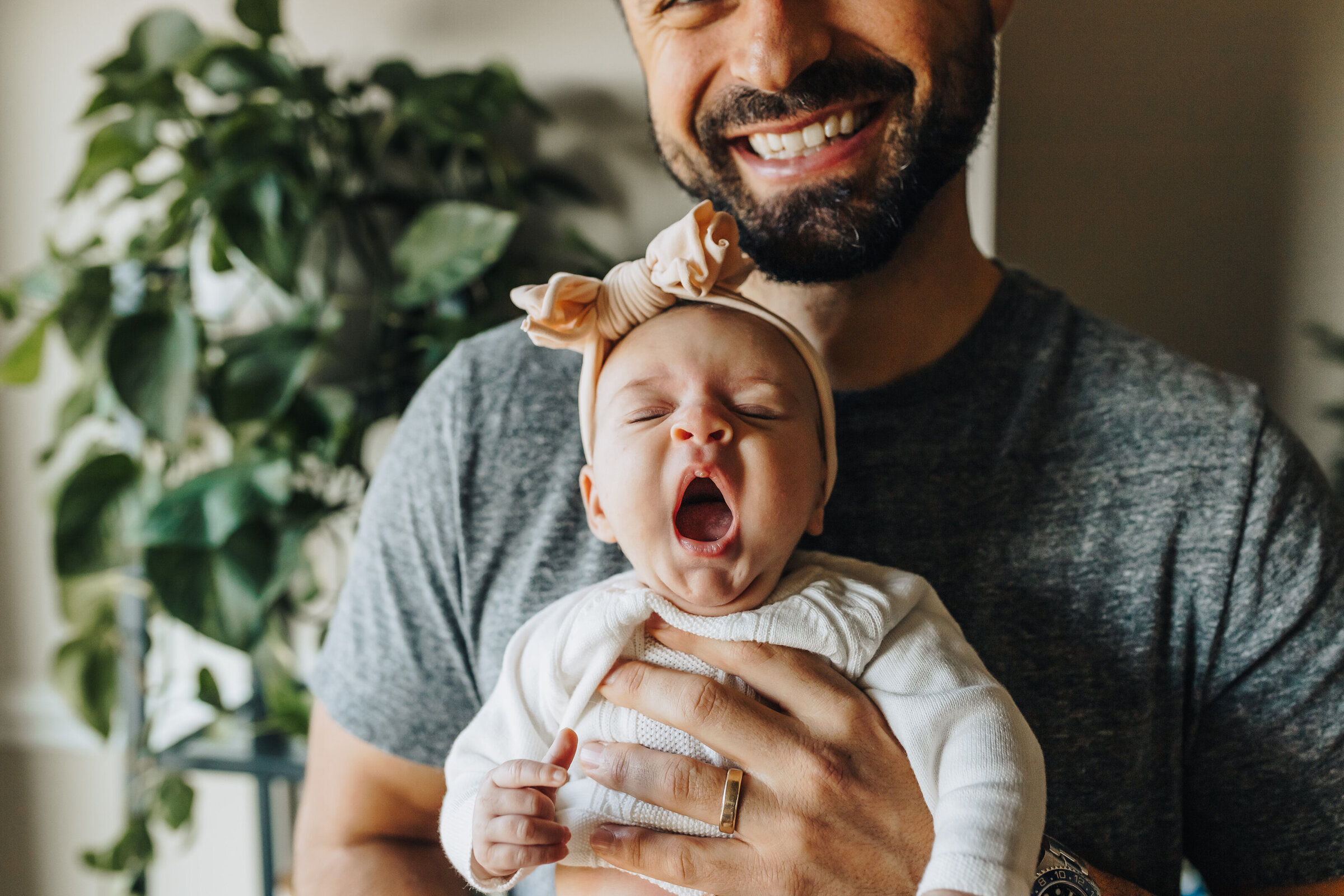 Baby Yawns Held By Smiling Dad