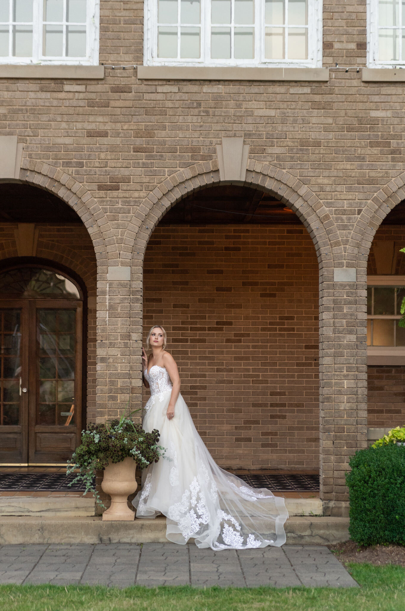 bride under a brick arch