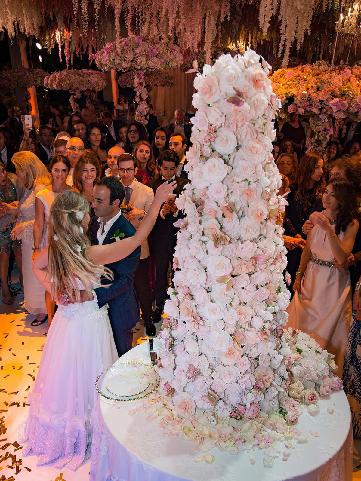 Tall centerpiece of pink and white flowers at wedding