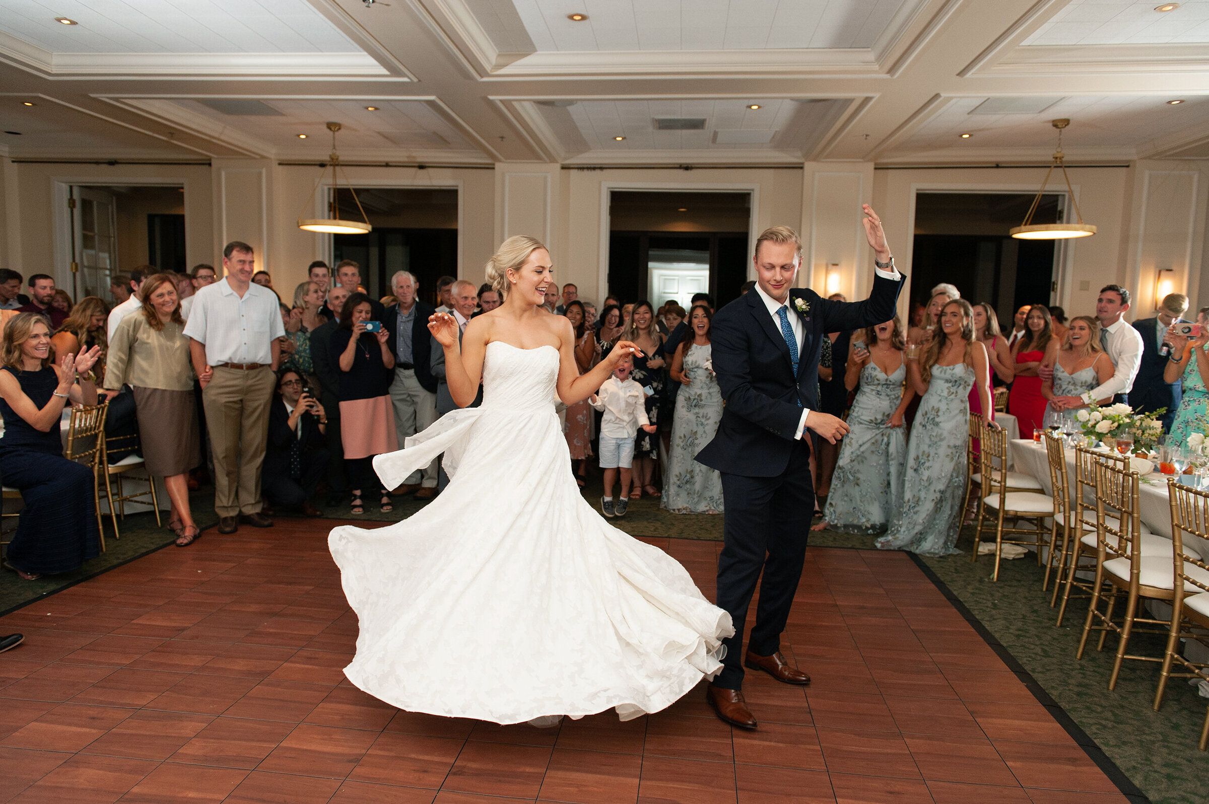 groom spins bride on the dance floor in ballroom wedding reception