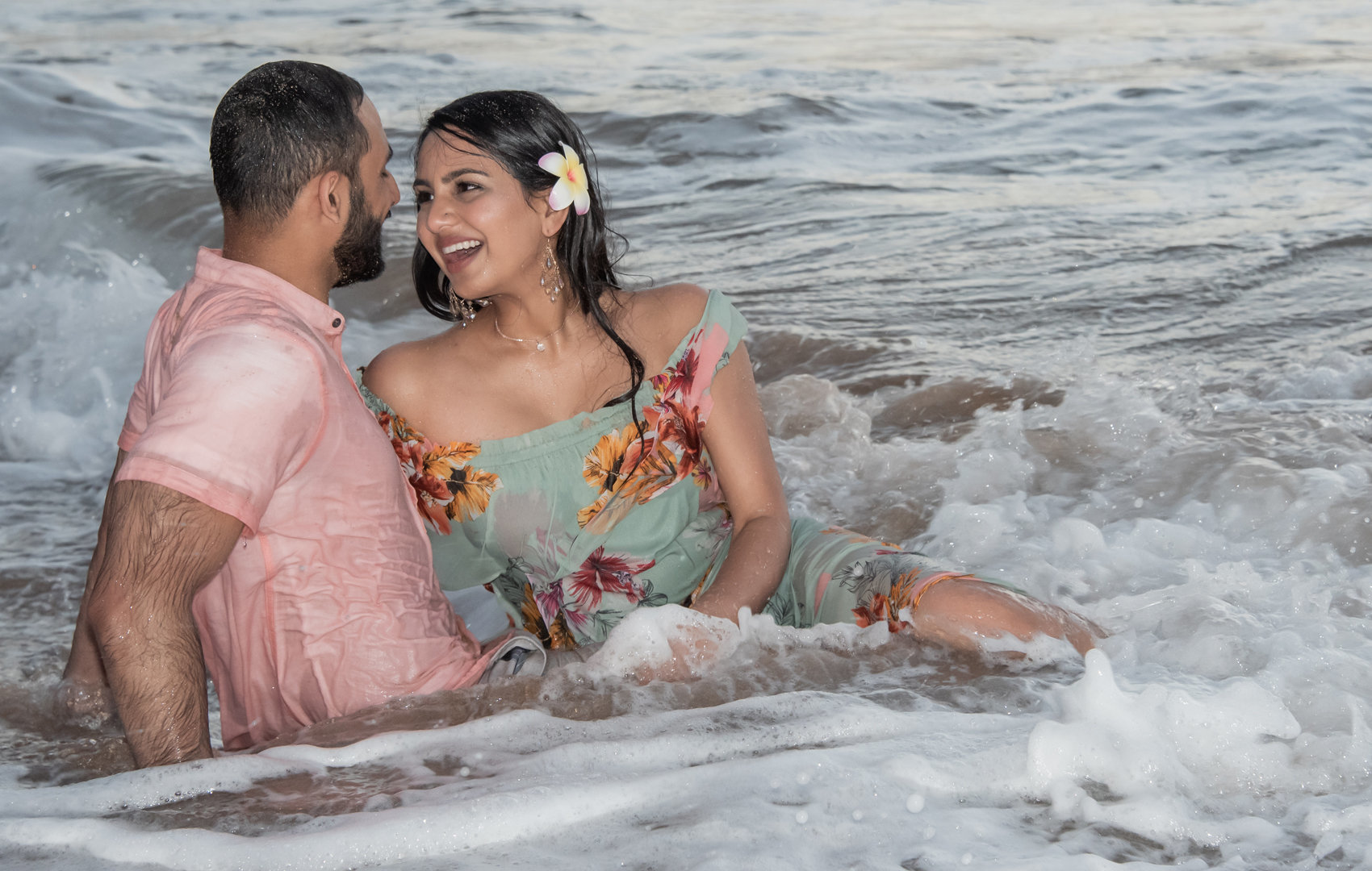 Indian couple kiss and have fun on the beach.