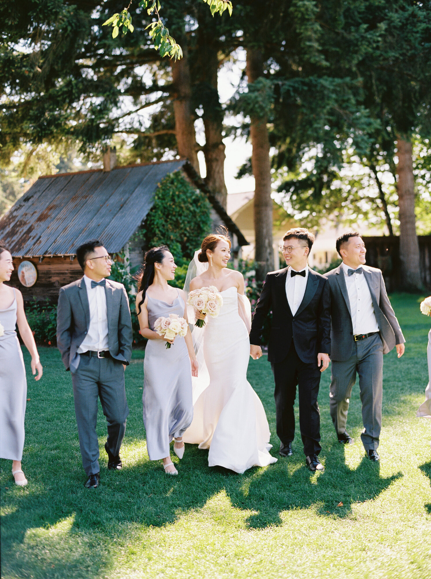 bridal party walking together at garden wedding