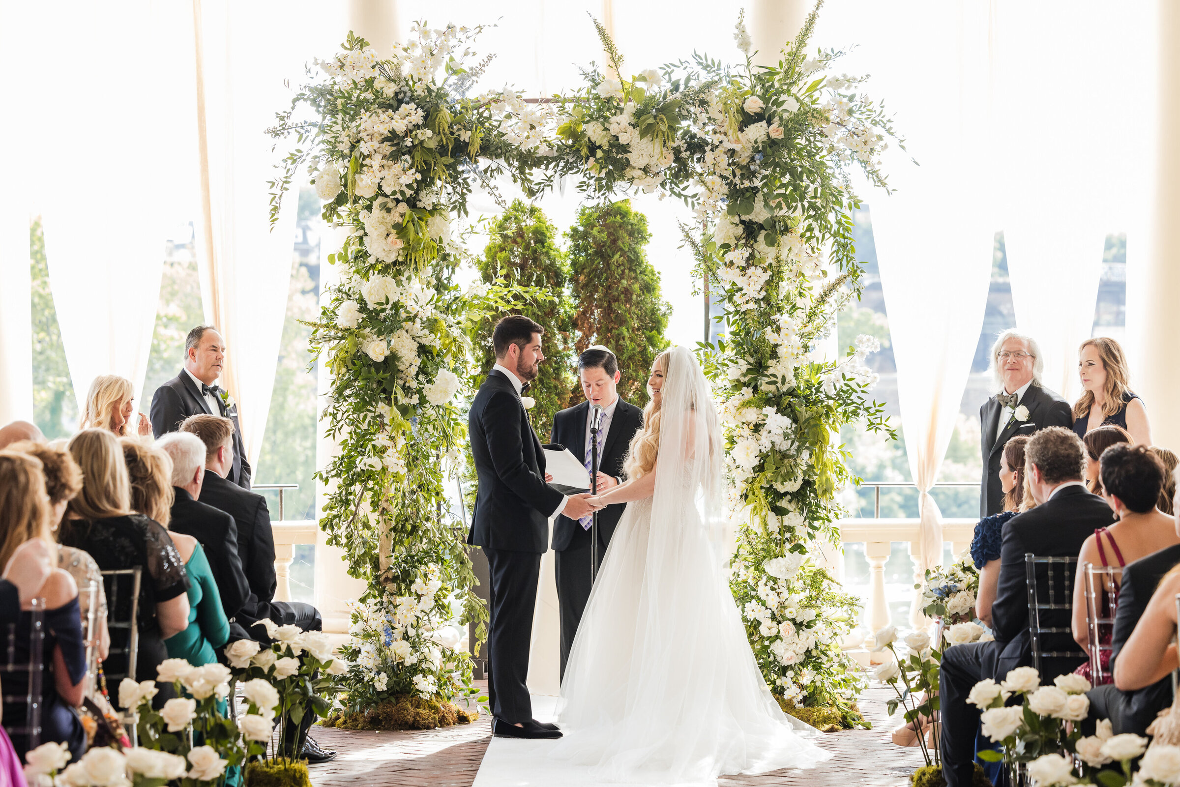 a luxurious Philadelphia wedding at Water Works, featuring an outdoor ceremony adorned in enchanting shades of green, white, and baby blue