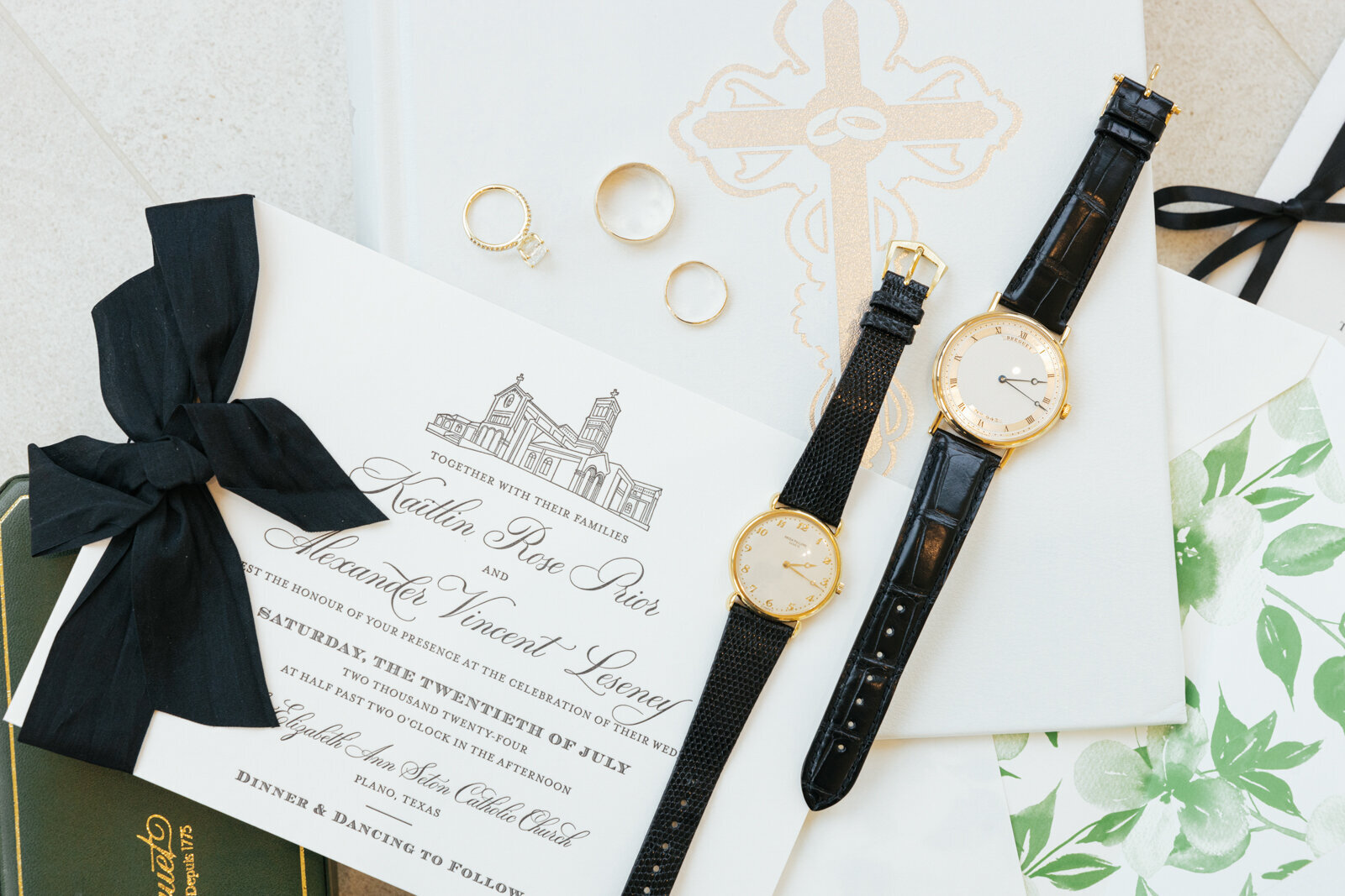 Wedding details shot featuring the invitation alongside a Patek Philippe watch and a Breguet watch.

