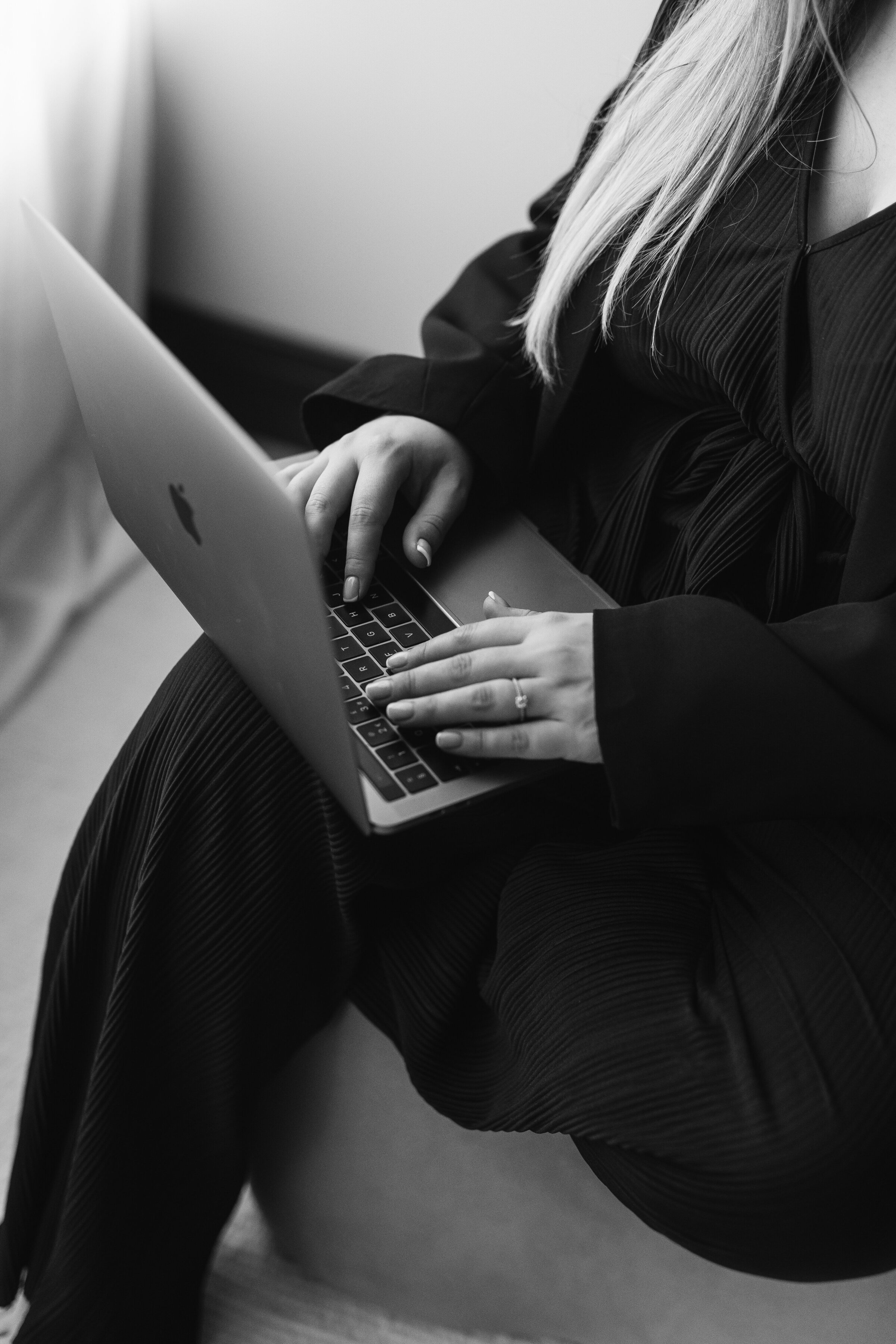 A girl typing on a laptop in Horsham photography session