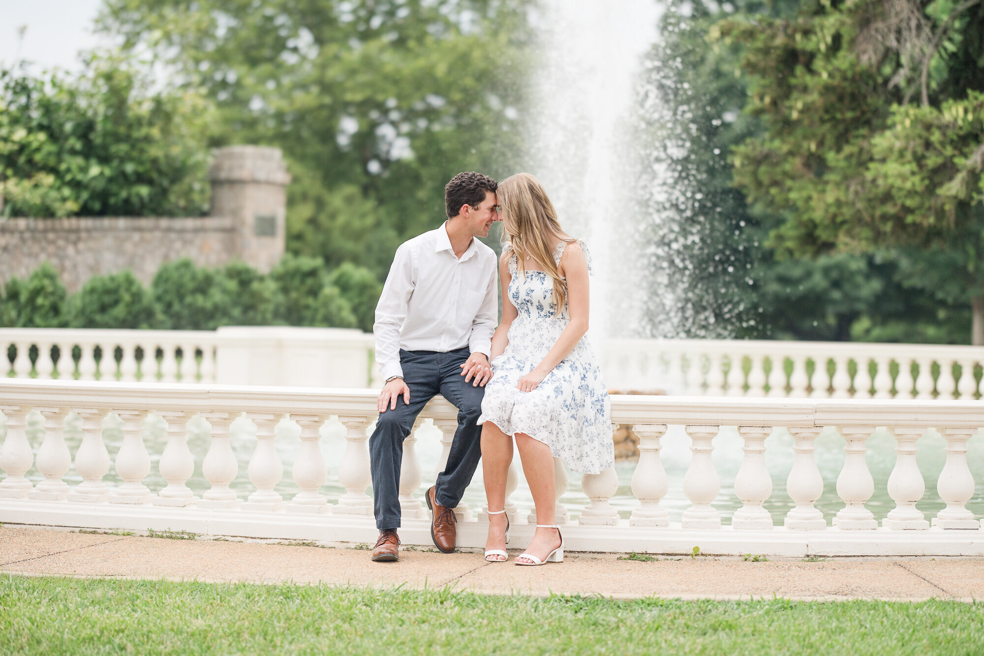 Engaged couple at a fountain
