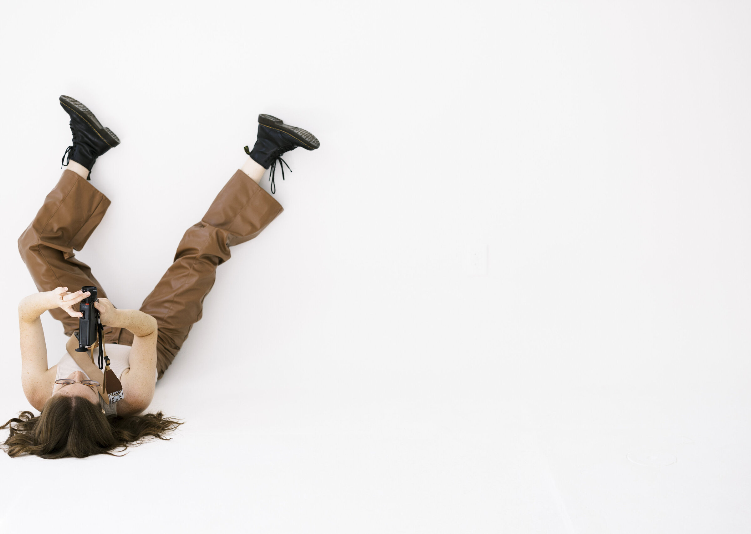 videographer laying upside down with camera