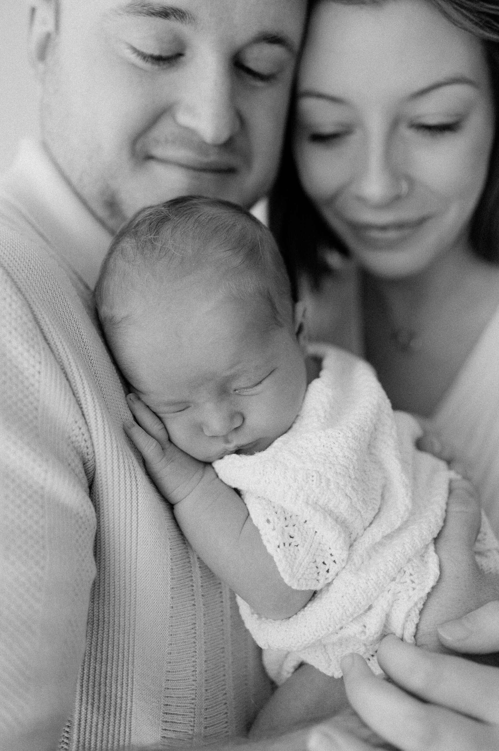 baby lying on Dad with Mum standing beside at studio in central York near Leeds and Harrogate