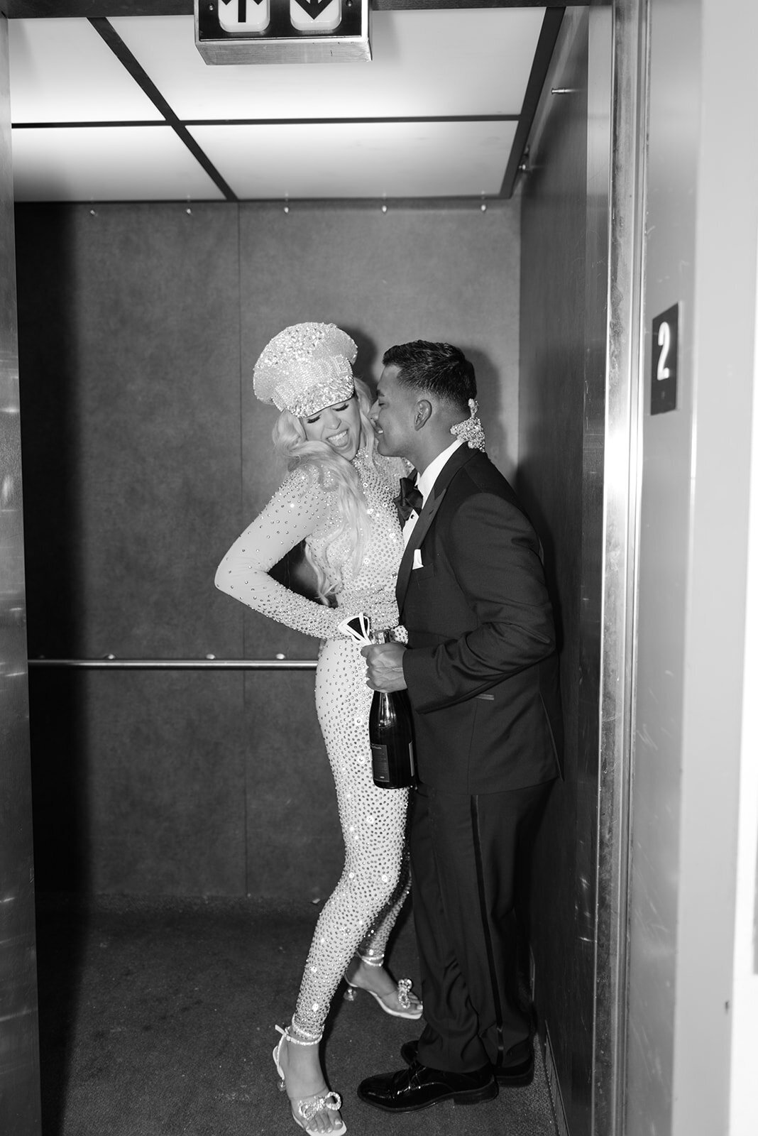 A bride and groom stand excited at the end of their wedding day, this vogue like photo shows a candid moment of the couple excited to be husband and wife.