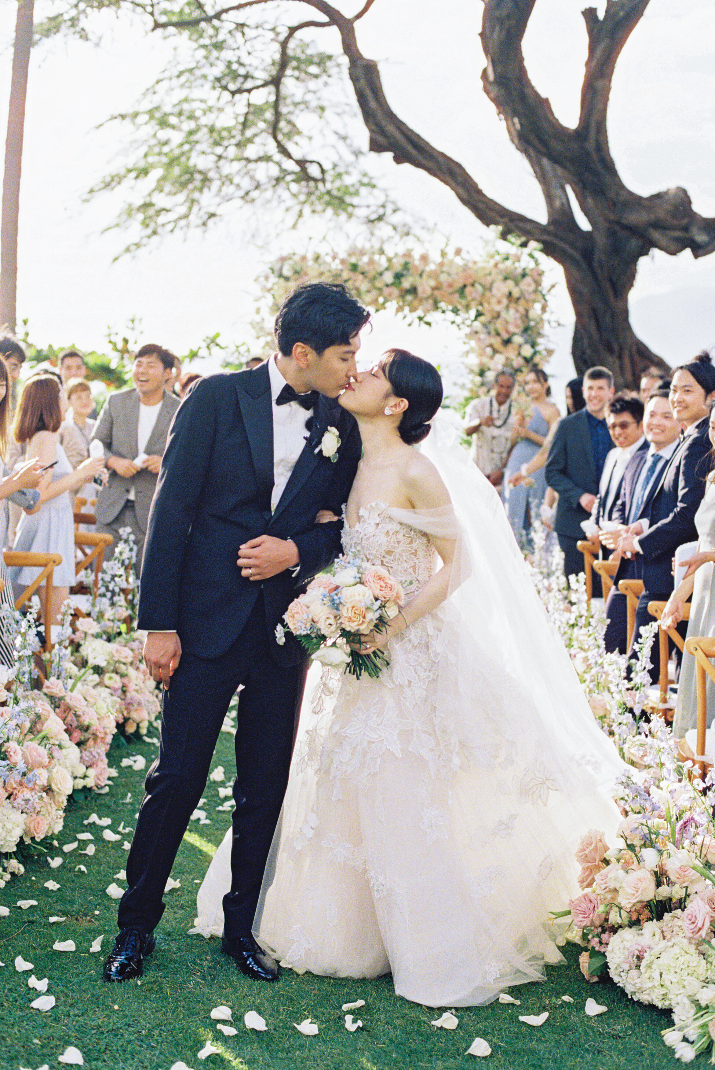 Wedding and Elopement Photographer, bride and groom stopping to kiss while walking down aisle