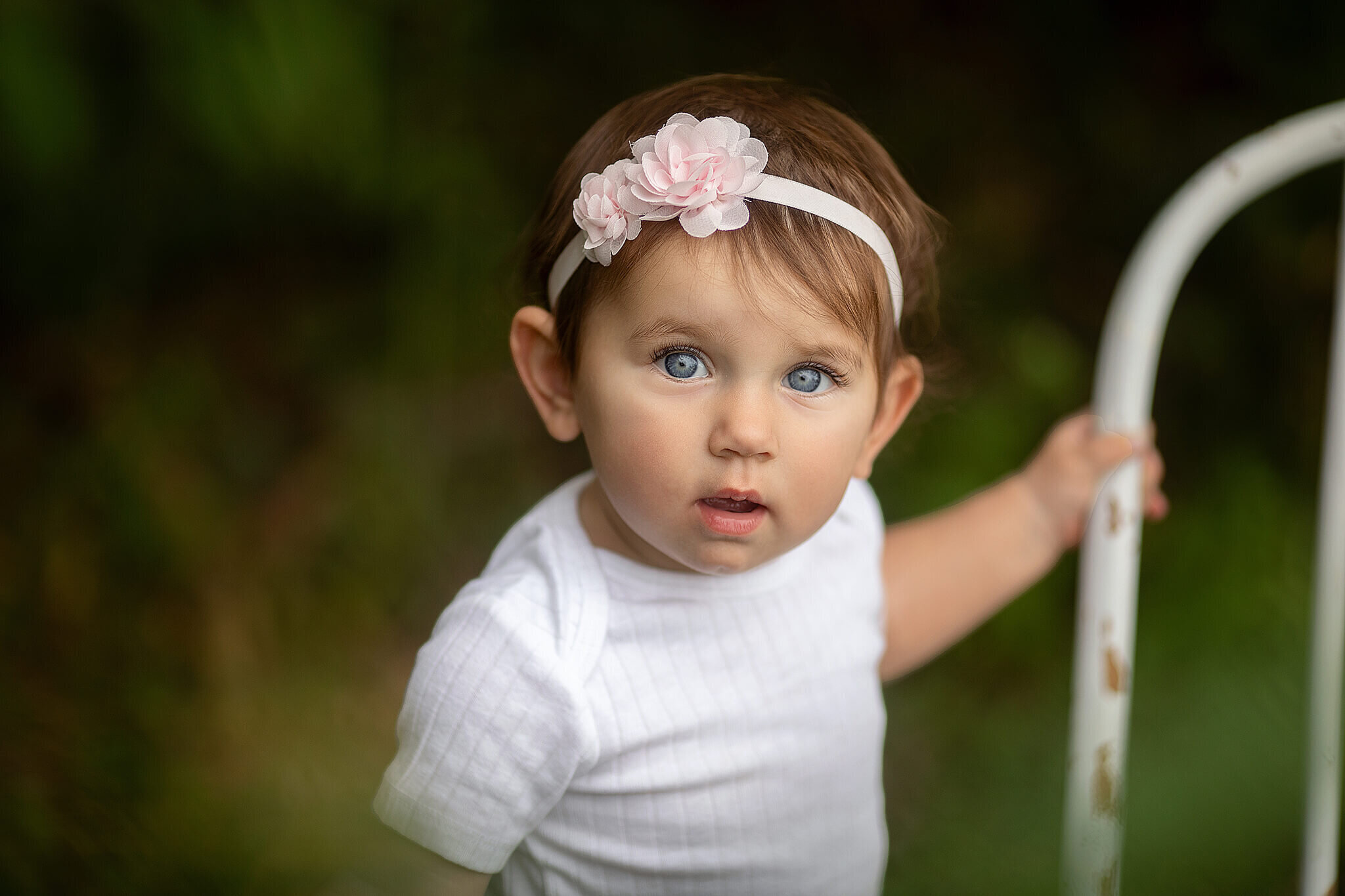 Up close photo of 1 year old girl standing outside
