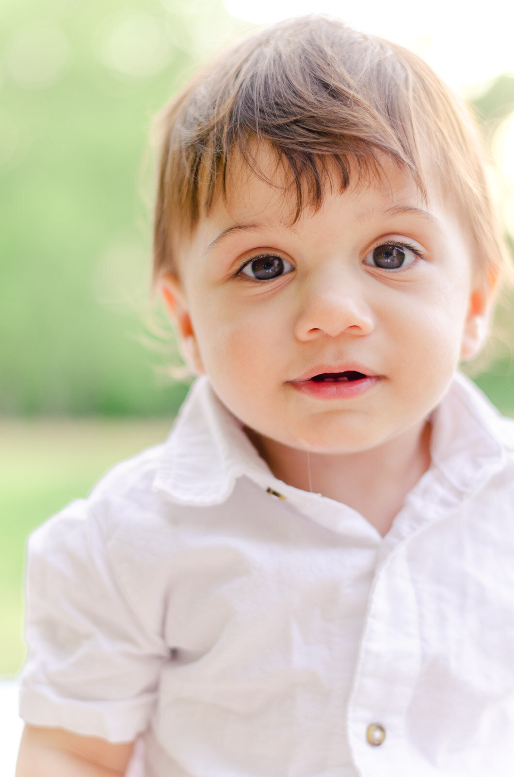 close up of baby boy in field