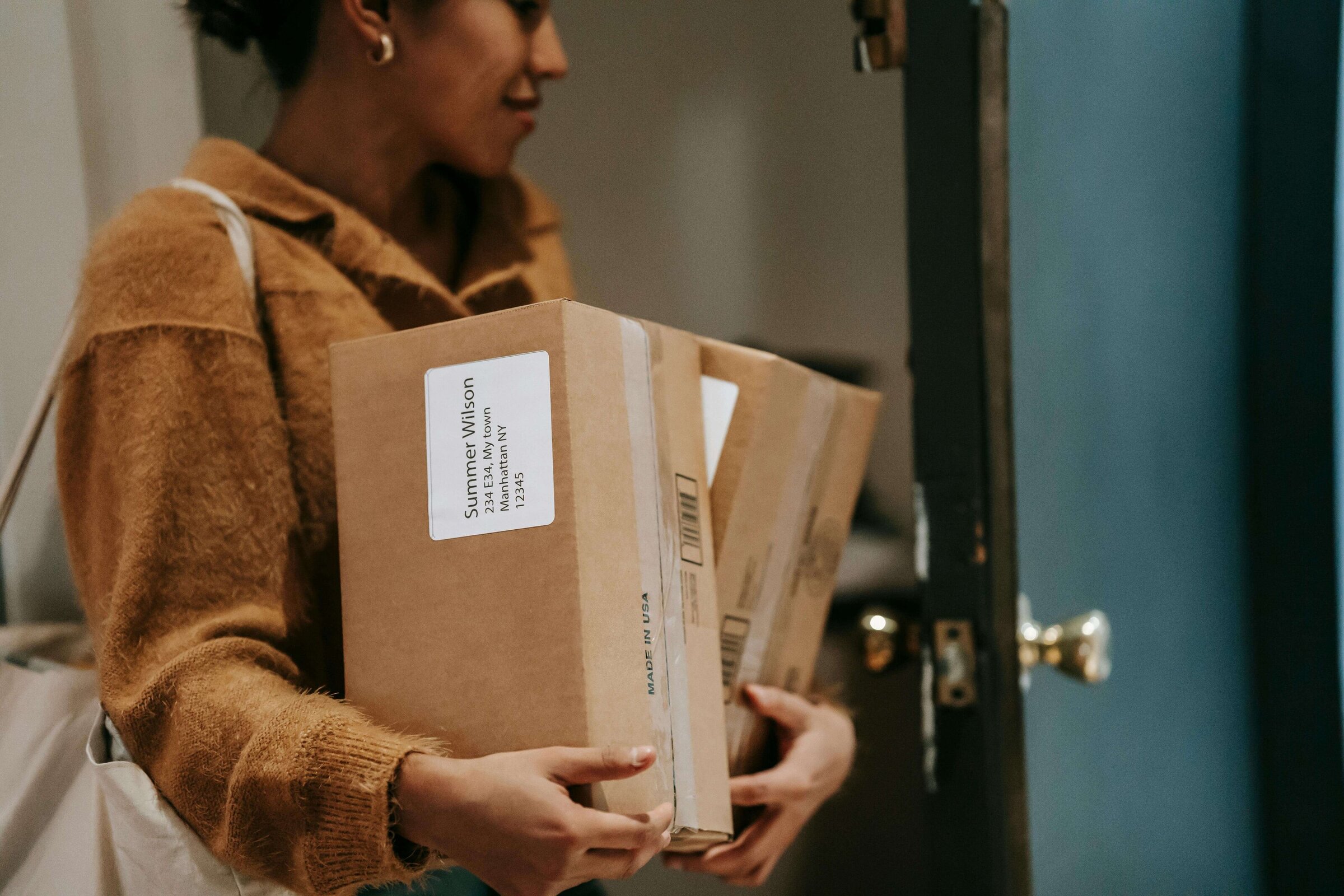 women bringing packages into house