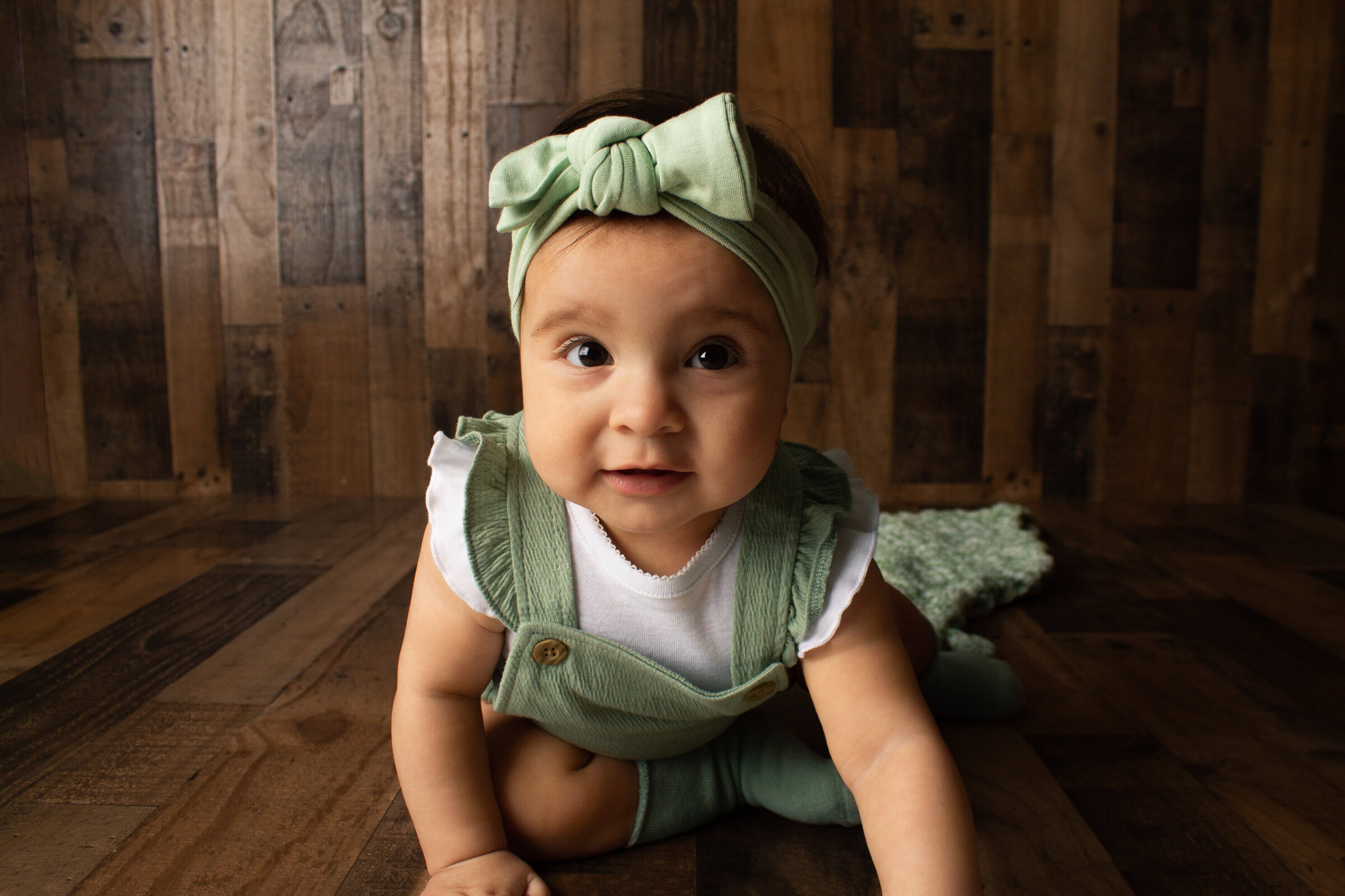 Zyla crawling foward for her milestone session  at the Minot AFB studio.