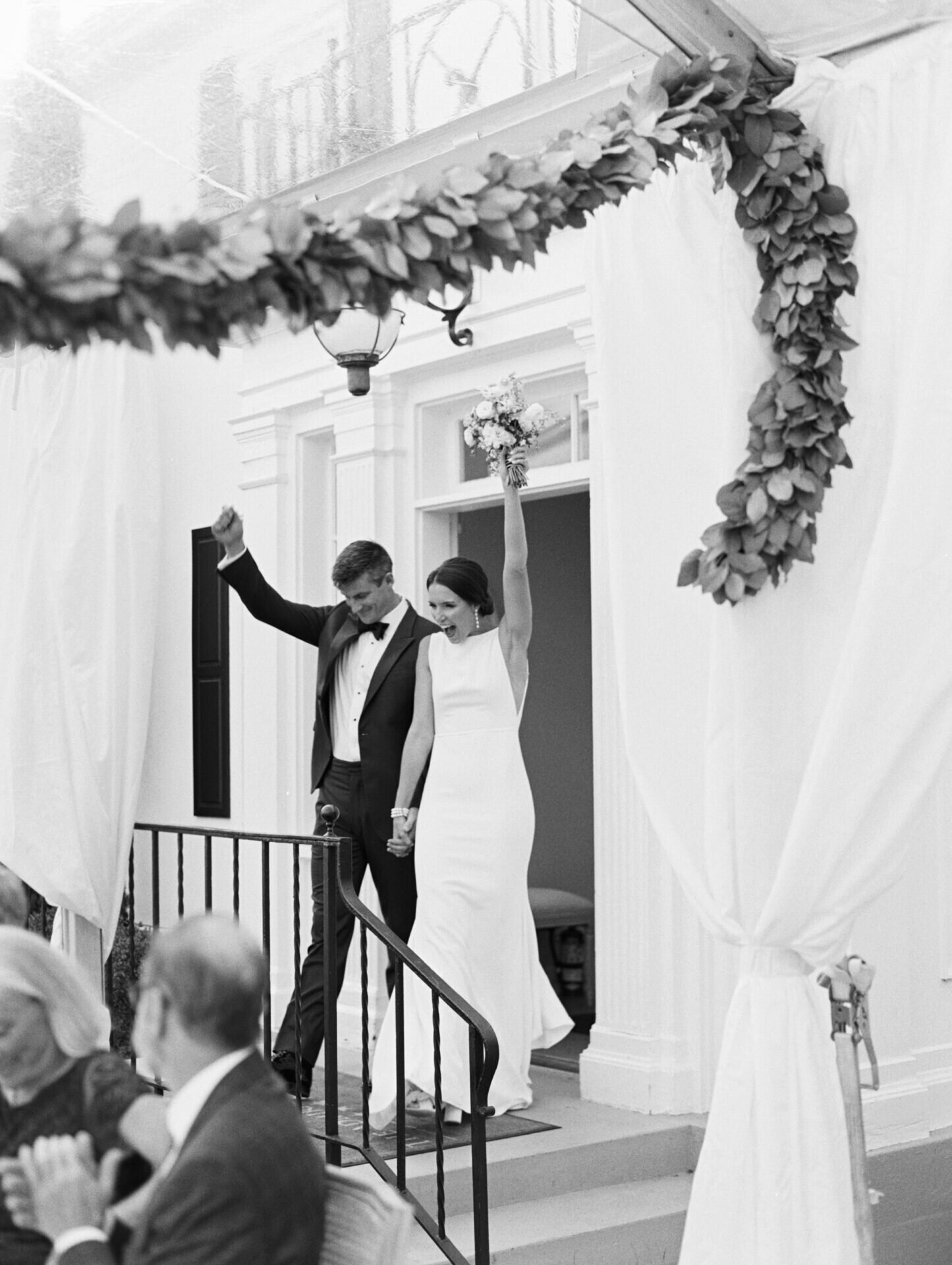 black and white film image of couples grand entrance into wedding reception