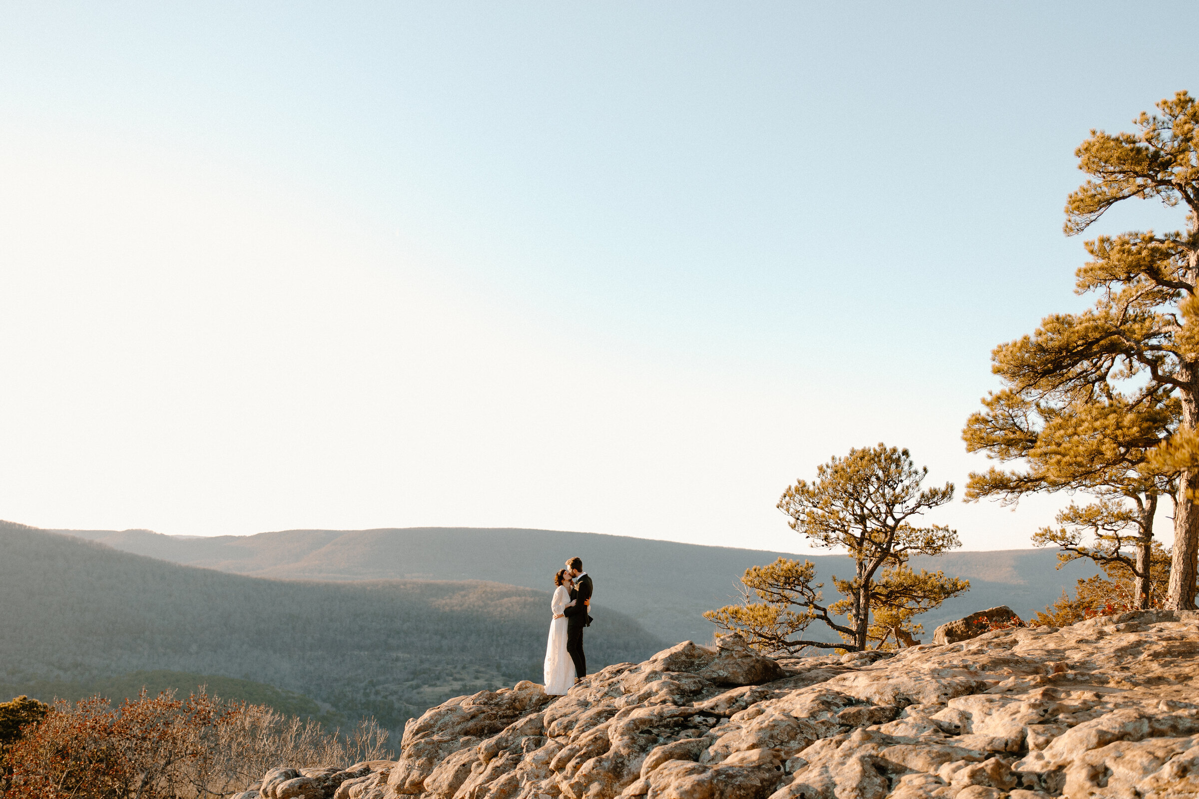 couple holding each other on a mountain top