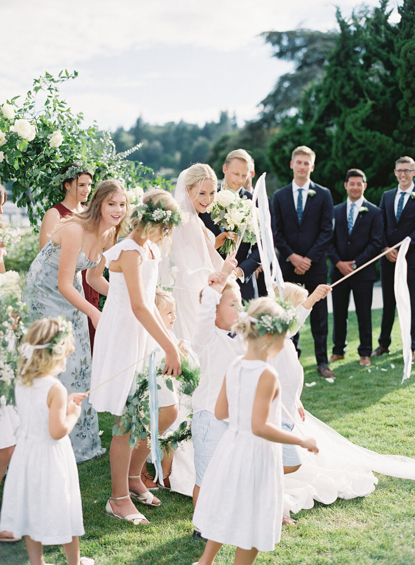 wedding children in floral crowns and all white at outdoor wedding on lake at seattle tennis club