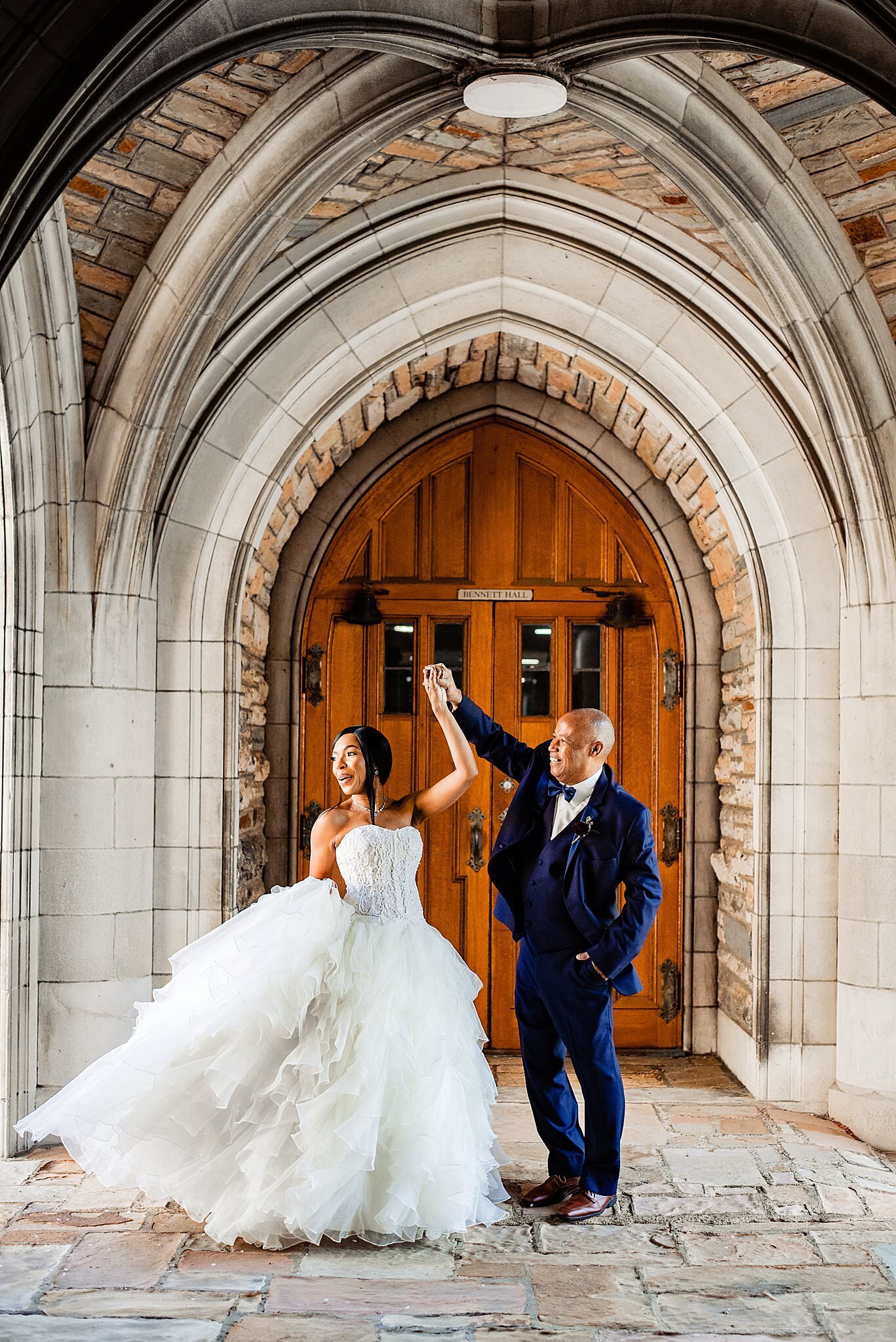 Couple dancing together under iconic archways at Scarritt Bennett Center
