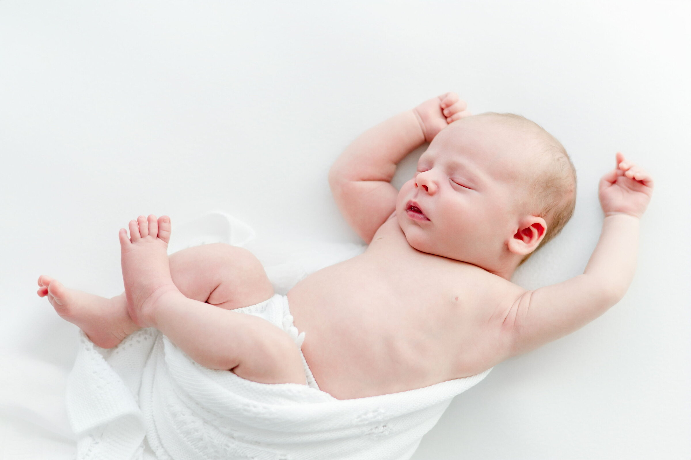 a sleeping newborn lays on a beanbag  in Kristie Lloyd's Nashville newborn photography studio