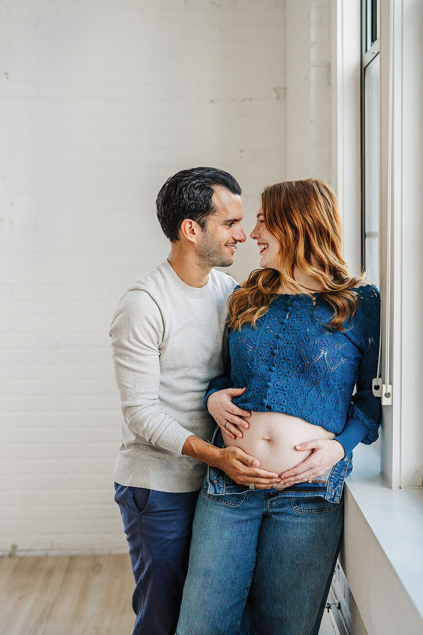 pregnant couple pose for maternity photos in boston