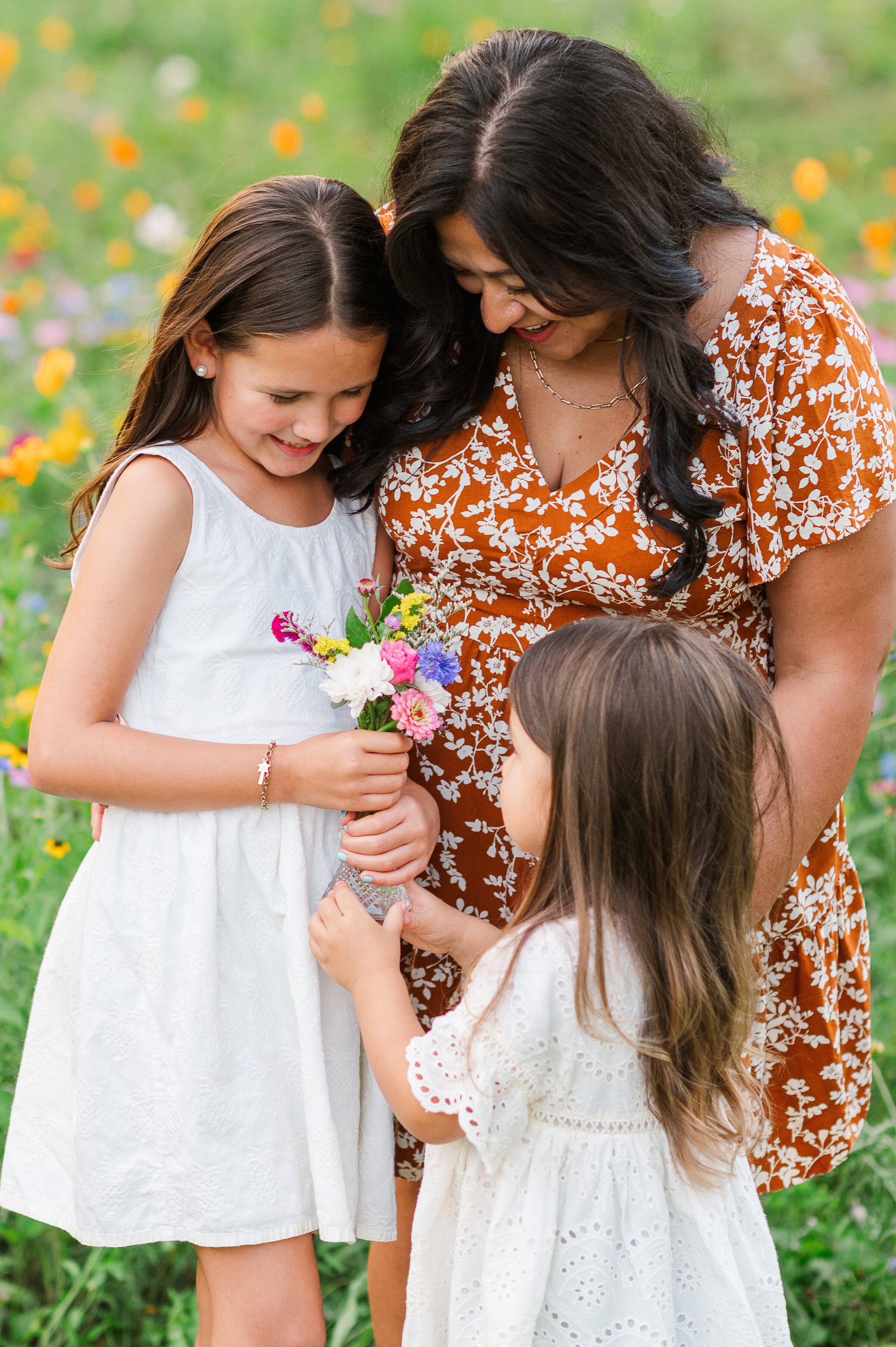 Sisters and mother smiling together during a playful fall mini session in Lancaster, PA