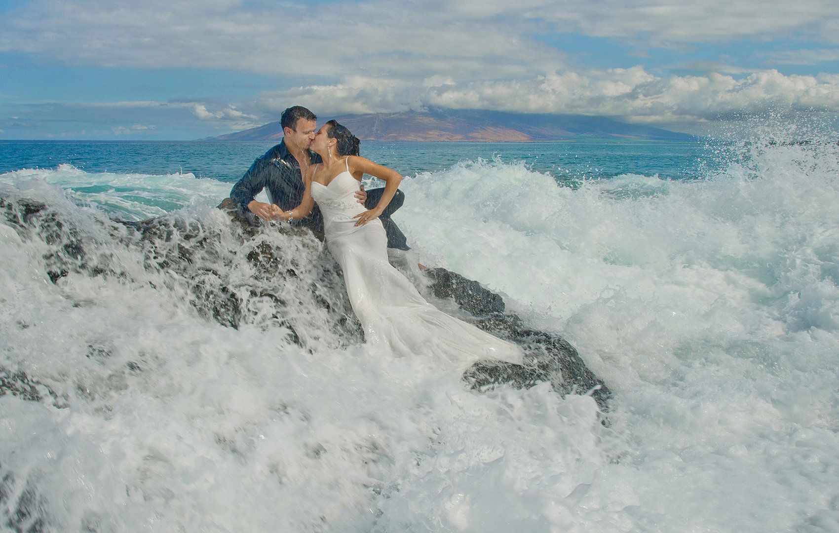 very wet wedding couple enjoy getting wet for their honeymoon shoot.