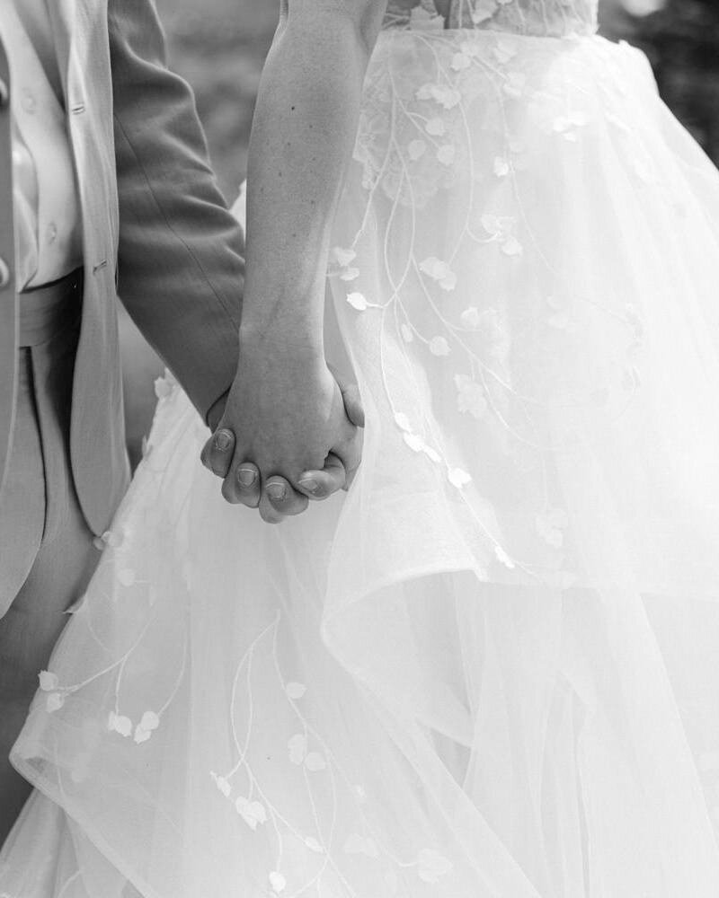 A timeless black and white photograph capturing only the hands of a bride and groom as they walk together after their elopement in Banff National Park. This intimate and artistic moment symbolizes love, connection, and the quiet beauty of their unforgettable day in the Canadian Rockies.