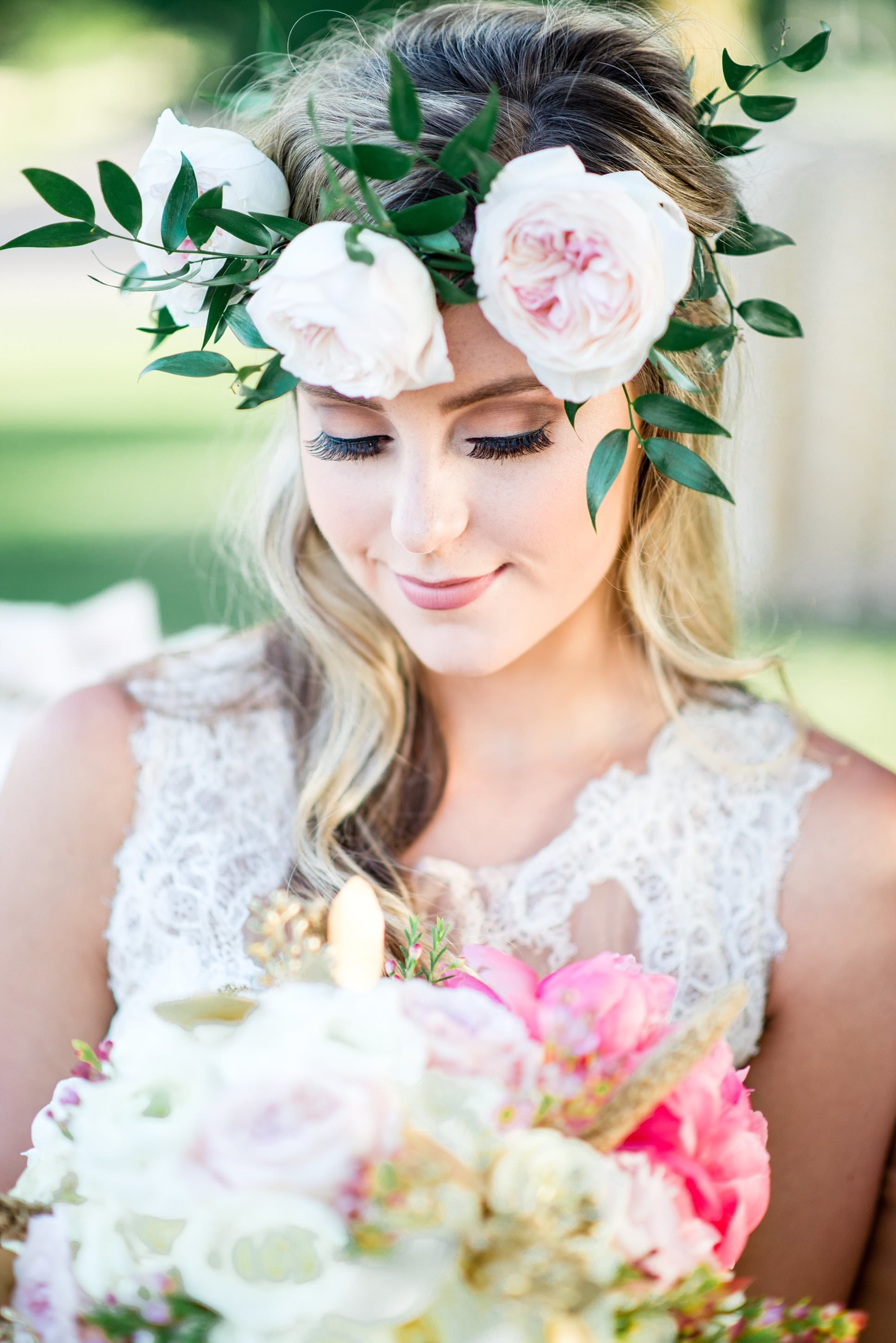 Close up photo of bride wearing a flower crown, soft pinks and greens