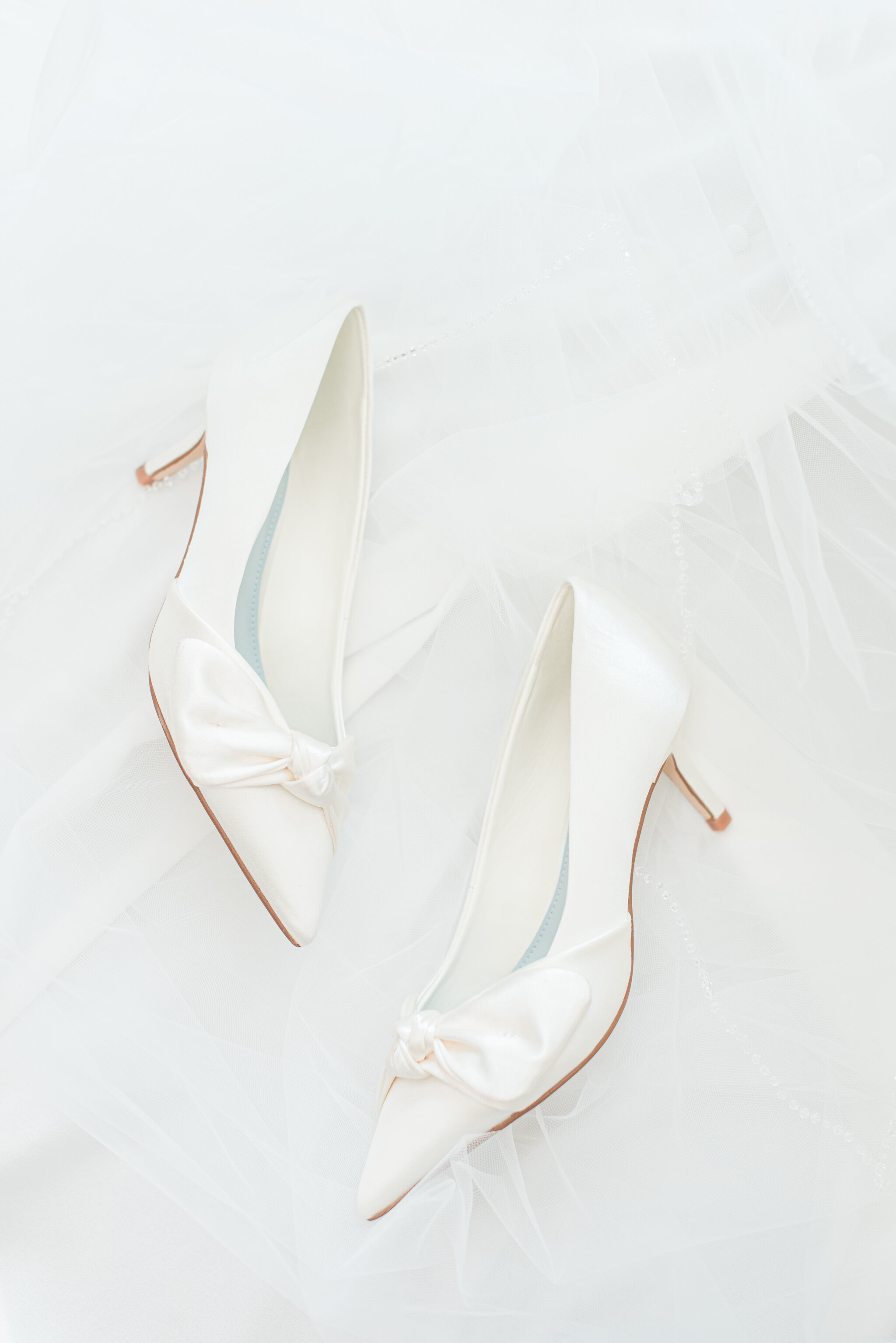 jimmy choo wedding shoes with veil behind it