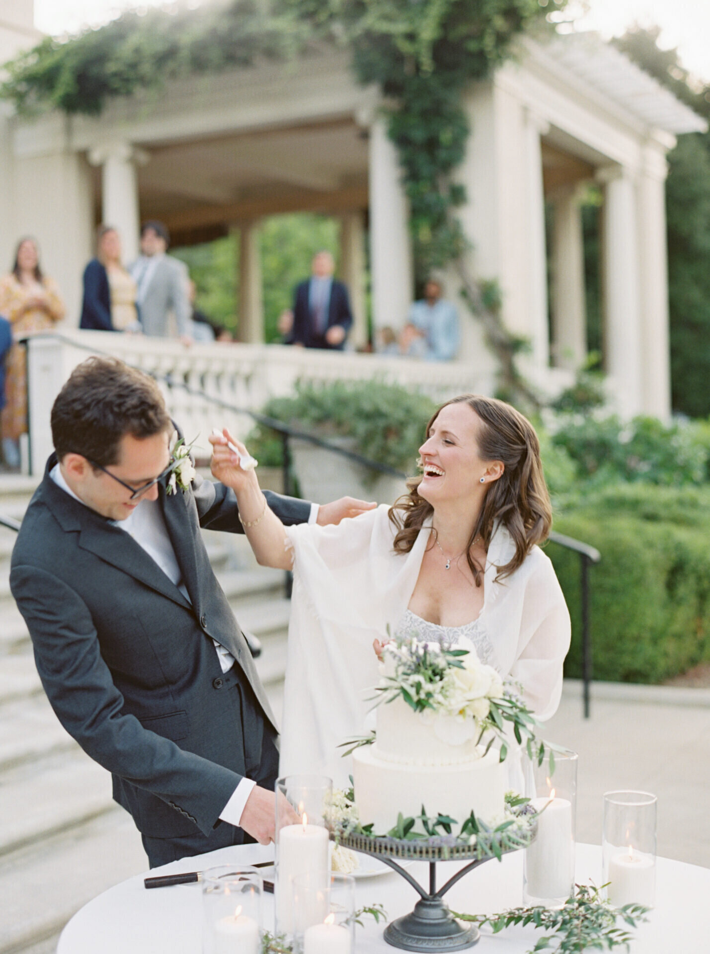 candid photo of bride feeding groom wedding cake