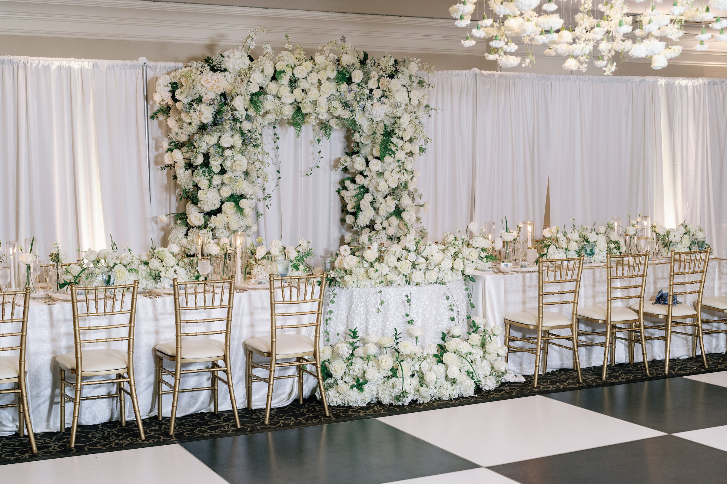 white roses and black and white checkered dance floor ballroom wedding reception