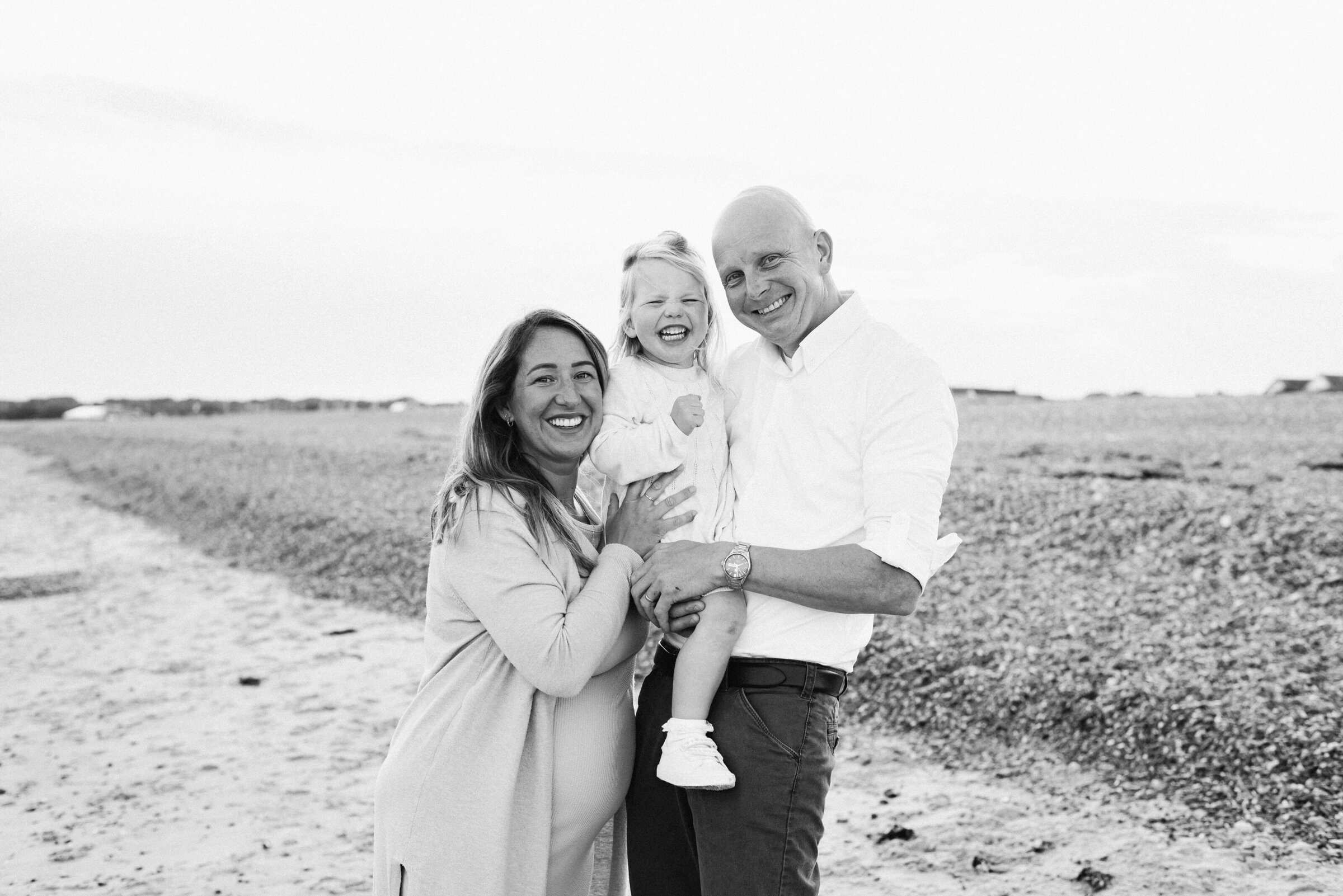 Mum and dad holding their daughter at a Billingshurst family photoshoot