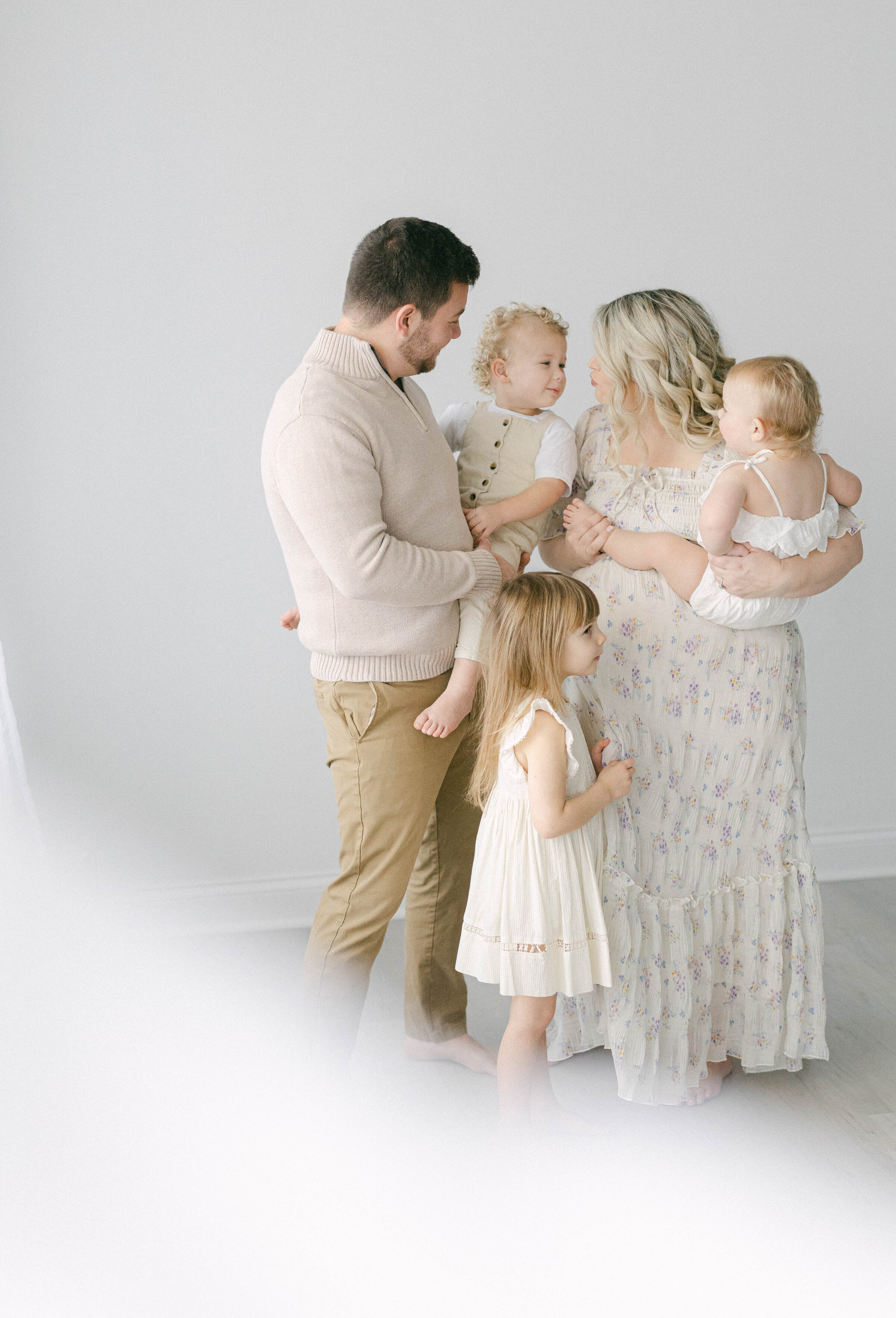family in studio smiling at eachother knoxville tennessee newborn photographer