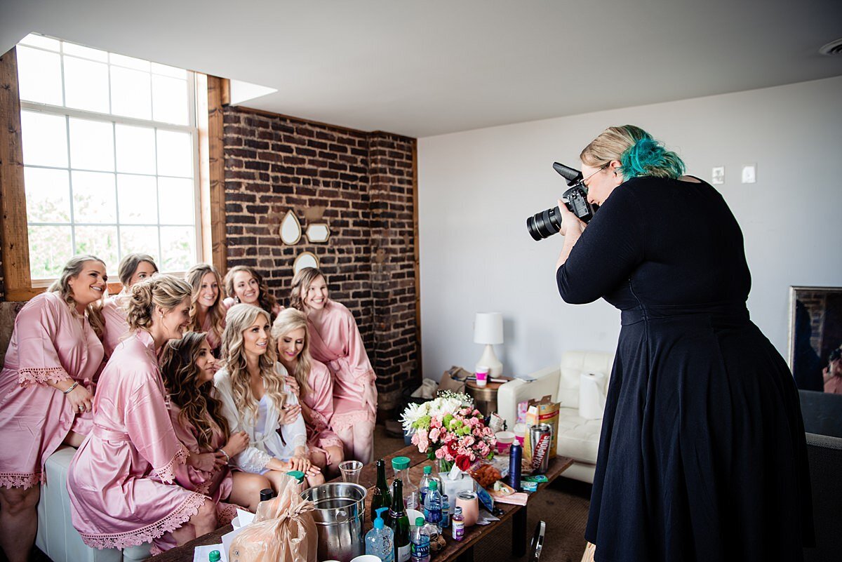 Mahlia taking photos of the bridesmaids in their wedding day robes